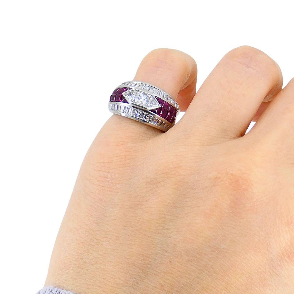 Cette bague dôme vintage, circa 1960, est en platine massif et présente un design géométrique audacieux serti d'un total de 1,83 carats de rubis taillés à la française. Au centre, la bague est rehaussée de trois types de diamants : 0,52 carats de
