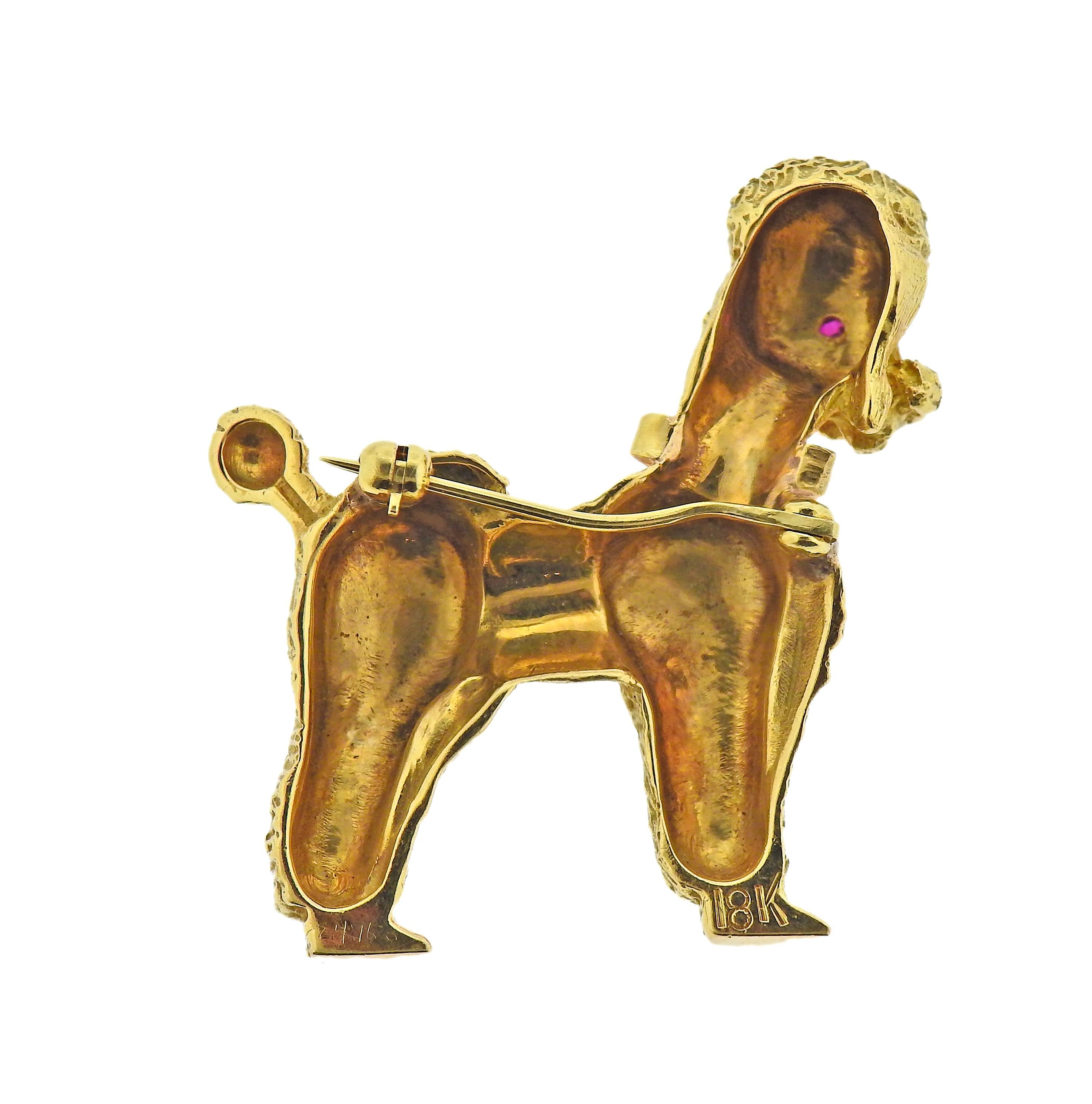 Circa 1960s 18k gold poodle dog brooch, with ruby eyes and collar. Brooch is 38mm x 32mm. Marked 18k. Weight - 16.3 grams.