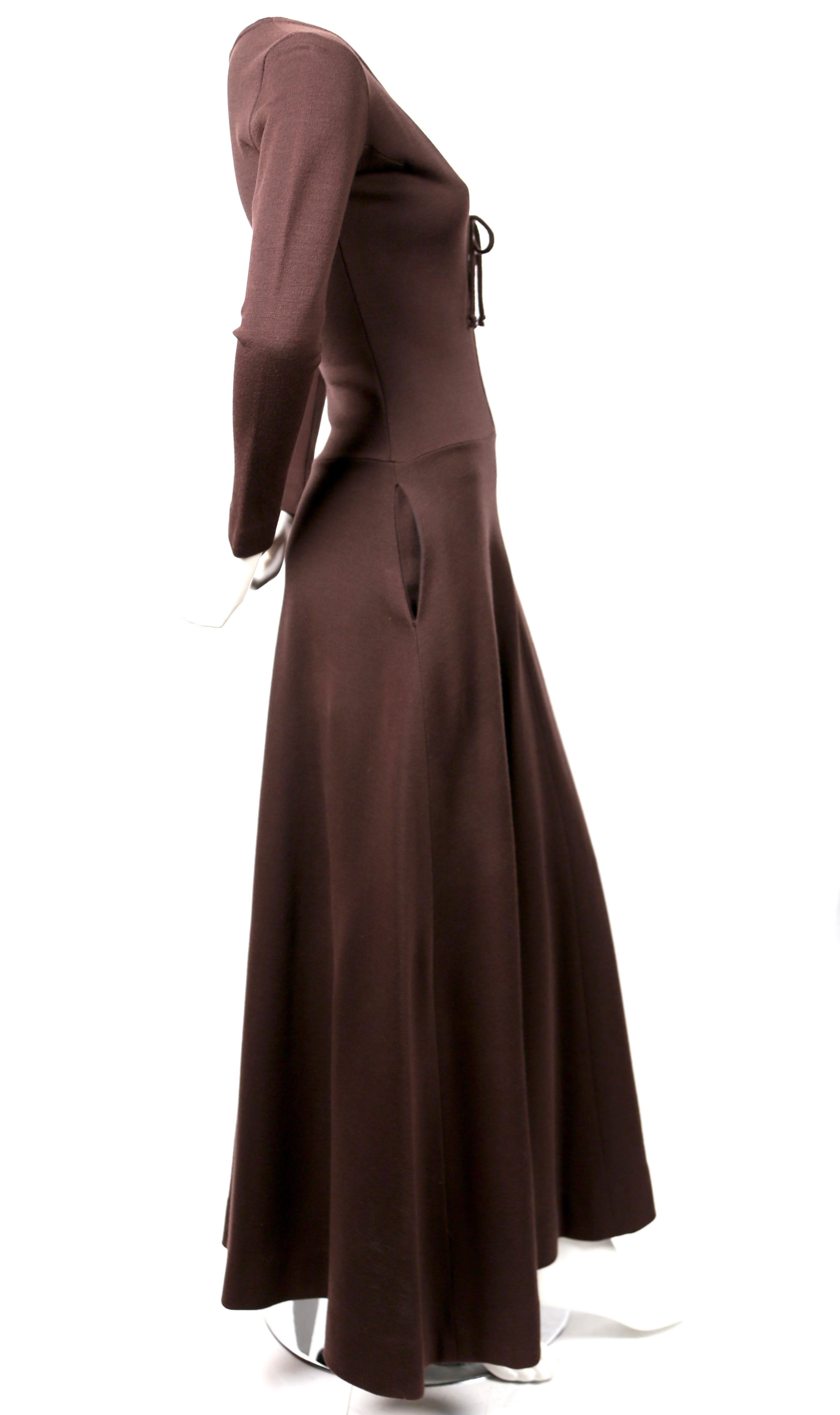 Deep brown, ankle-length, wool dress with plunging deep V neckline and long sleeves designed by Rudi Gernreich dating to the 1960's. Labeled a size 8 however this best fits a US 2 to 4. Dress was not clipped on size 2 mannequin. Hidden pockets at