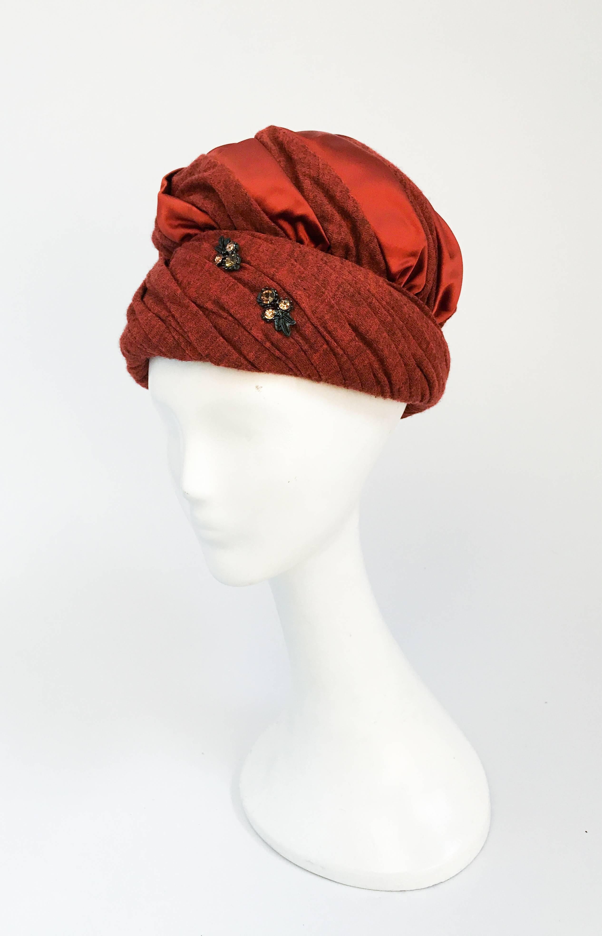 1960s Rust Jersey and Satin Turban with Rhinestone Embellishment. Rust jersey and satin turban with rhinestone accent. 22-inch circumference (medium).