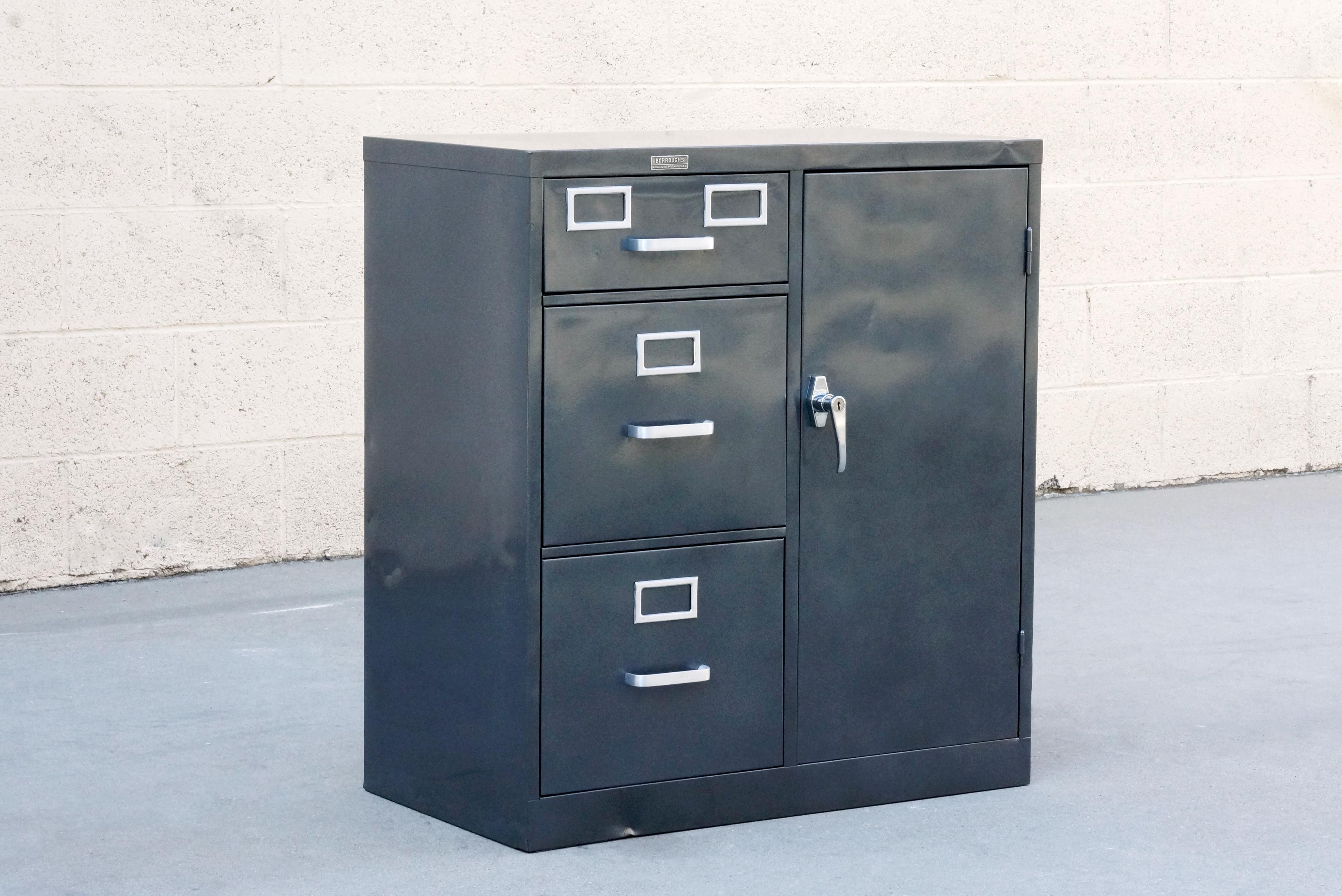 Classic American industrial safe cabinet by Borroughs, circa 1960s. We refinished this heavy duty steel piece in metallic grey (GR02) and brushed out the aluminum hardware to accentuate its All-American industrial styling. Fully-functional; key and