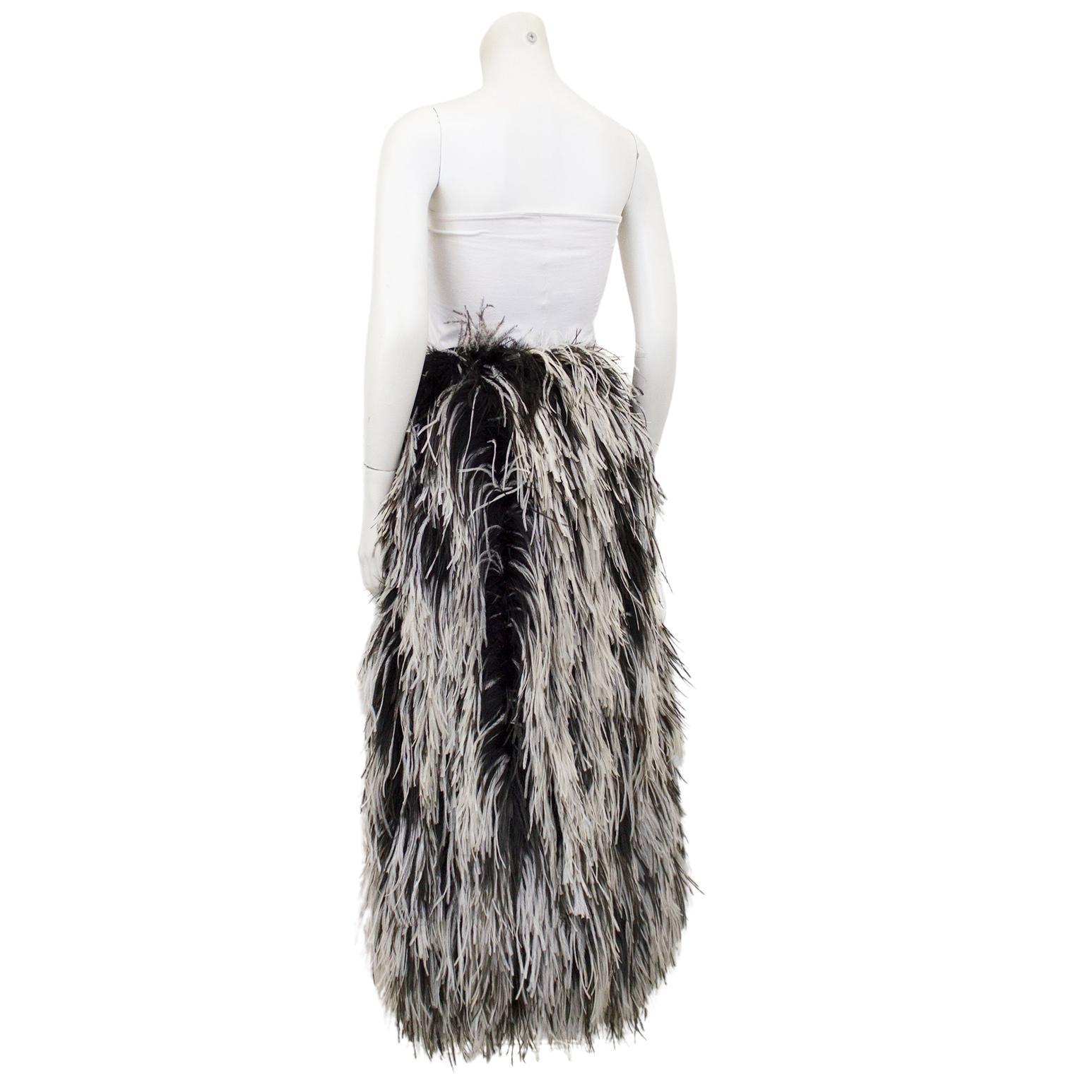 The most fabulous skirt ever. 1960's Saks Fifth Avenue, featuring all over black and white ostrich feathers. The skirt is straight line style, however the feathers add lots of volume and personality. High waisted with black lining and a black fabric