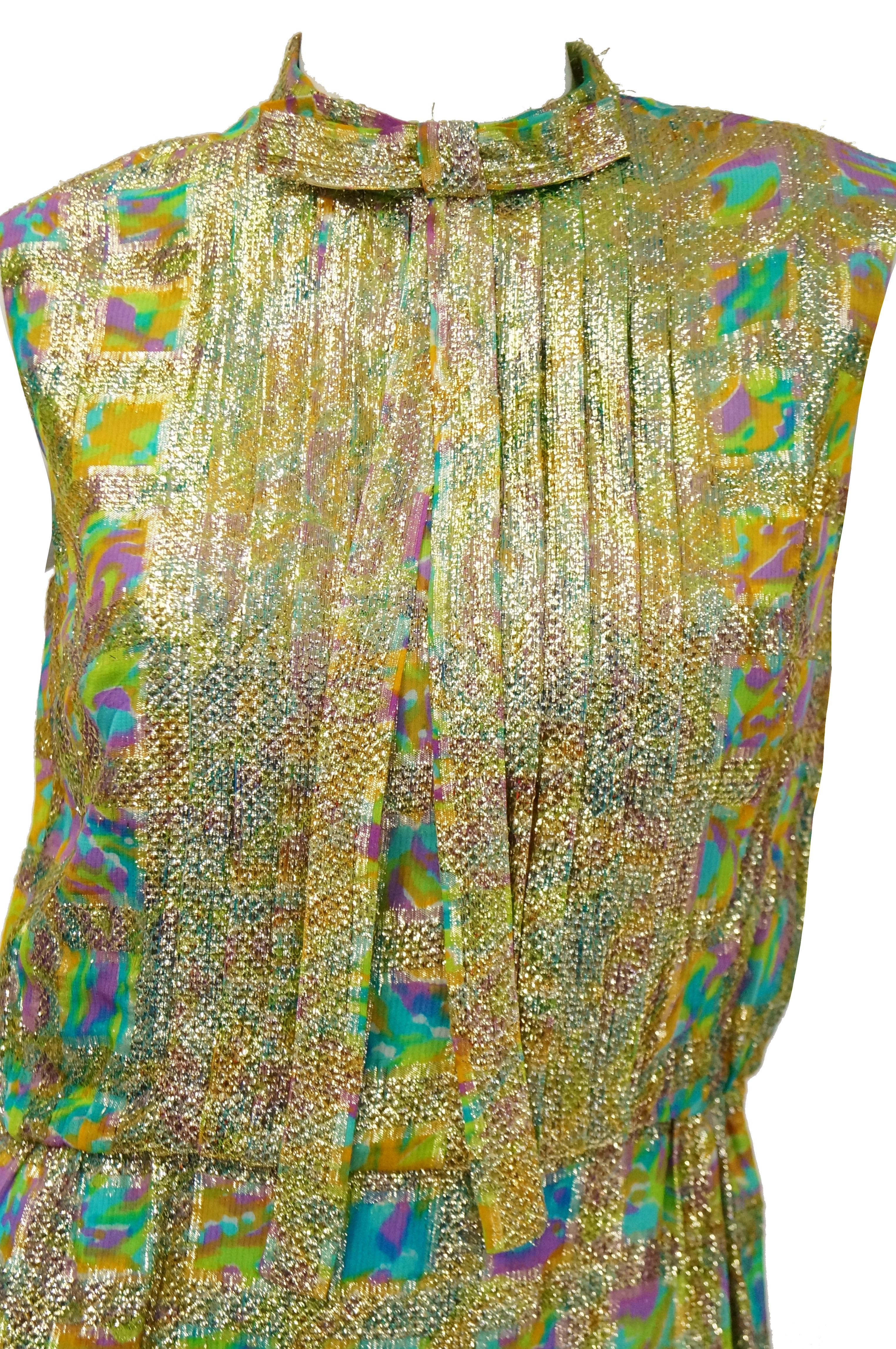 We love this fantastic, bold shift dress and jacket by Saks! The dress falls below the knee, is sleeveless, and has a faux turtleneck with a tie - able bow accent. The dress has a blouson waist, and the bodice is accented by tuxedo blouse pleating.