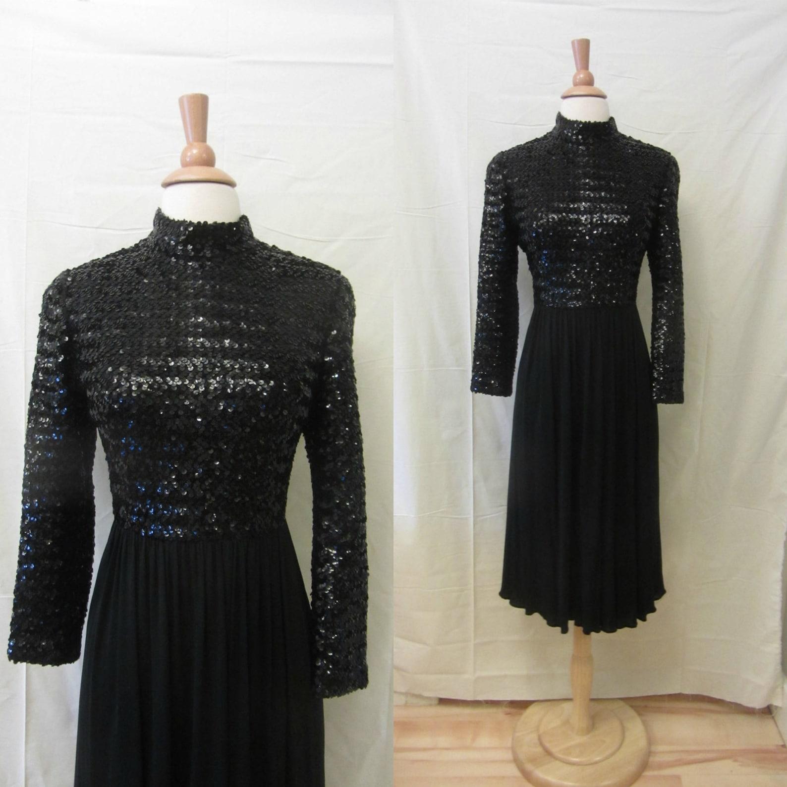 1960s Saks Fifth Avenue black cocktail dress
Paillette sequin knit bodice
mock neck collar
long sleeves
free flowing double layered jersey skirt
falls to just below knee length
bodice is lined
back zip closure

✂----------------------
Bust