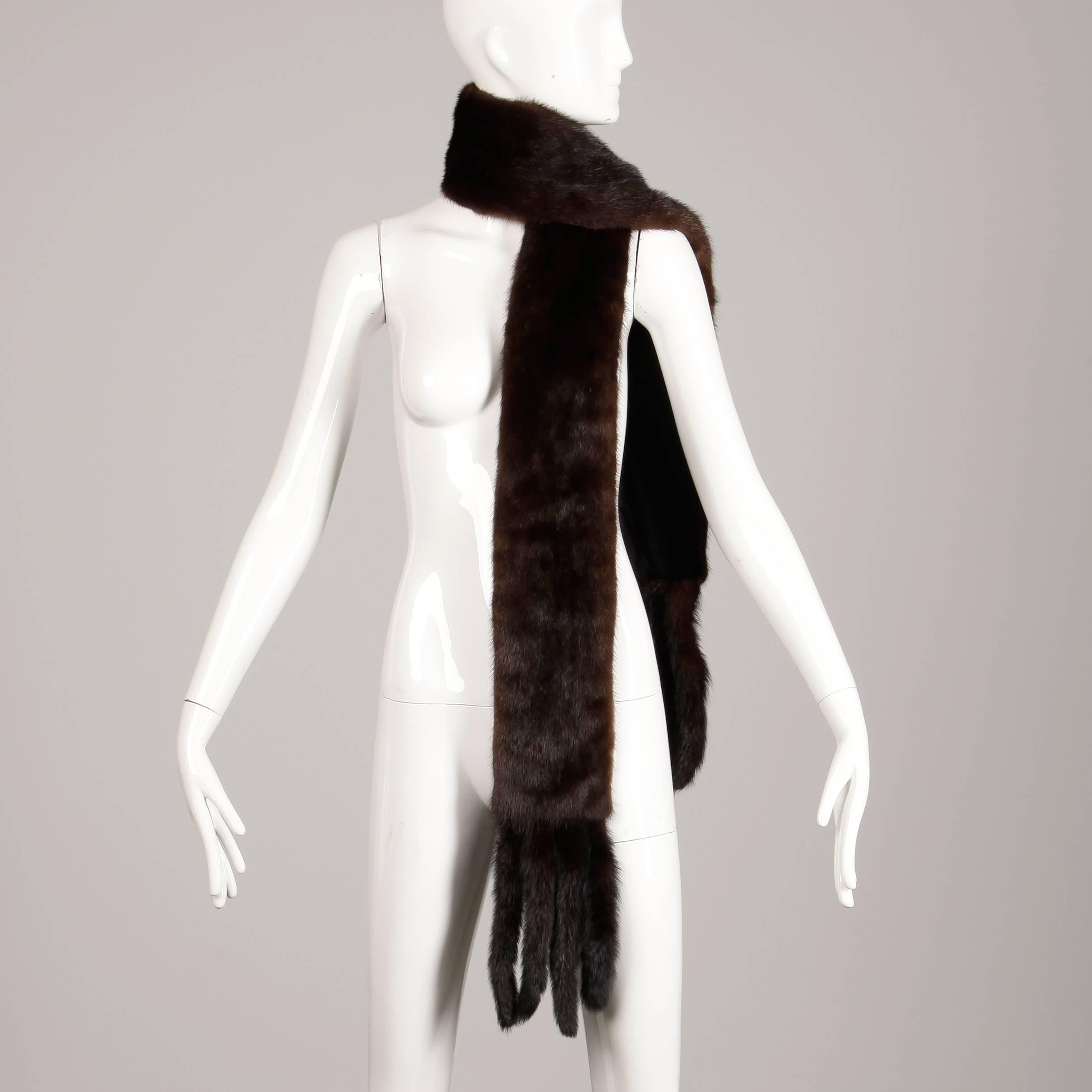 Gorgeous vintage mahogany mink fur scarf or fling with mink tail trim at both ends. Full pelts are in excellent condition and are nice a plush. Fully lined. The width measures 5