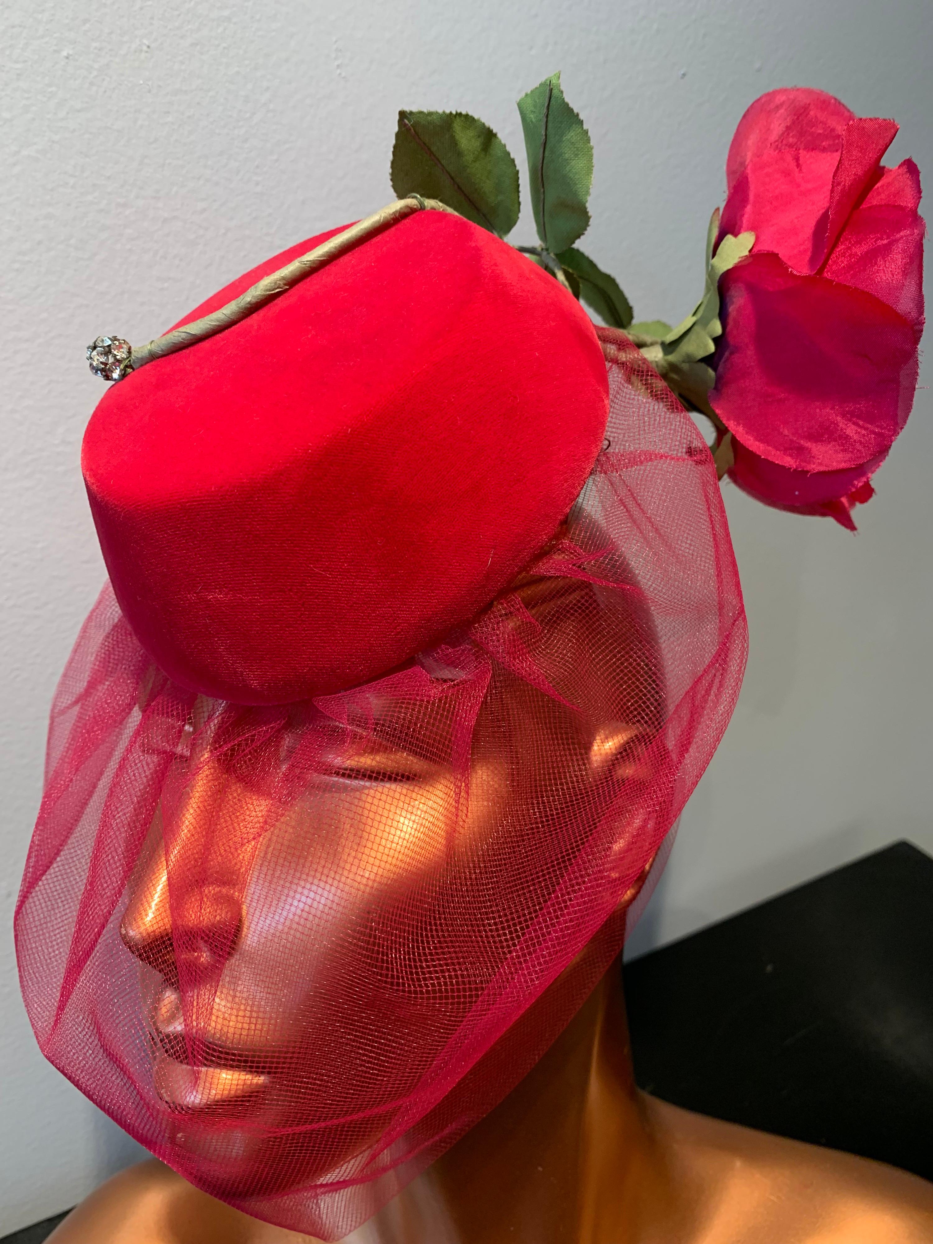 1960s Sally Victor Shocking Pink Toy Pillbox Hat W/ Dramatic Silk Rose & Veil. Hat is a silk velvet demi-chapeau style with interior comb for secure wear. Veiling is semi-opaque in coordinating pink. Flower stem is embellished a tip with a