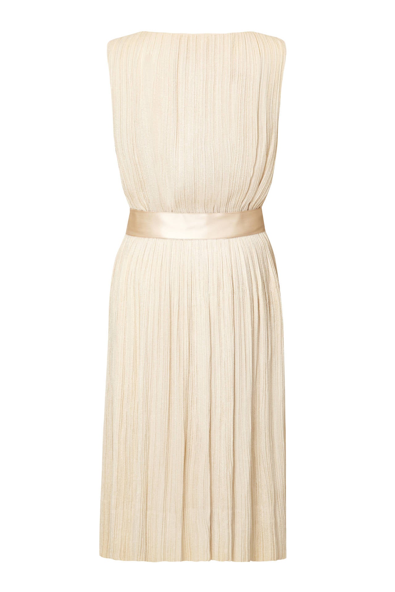 Gorgeous and very sophisticated original vintage 1960s dress by Ferdinando Sarmi of New York.  Of the softest and finely pleated cream silk with a cream satin bow belt and button stand.  It fastens down the front with poppers and is fully lined with