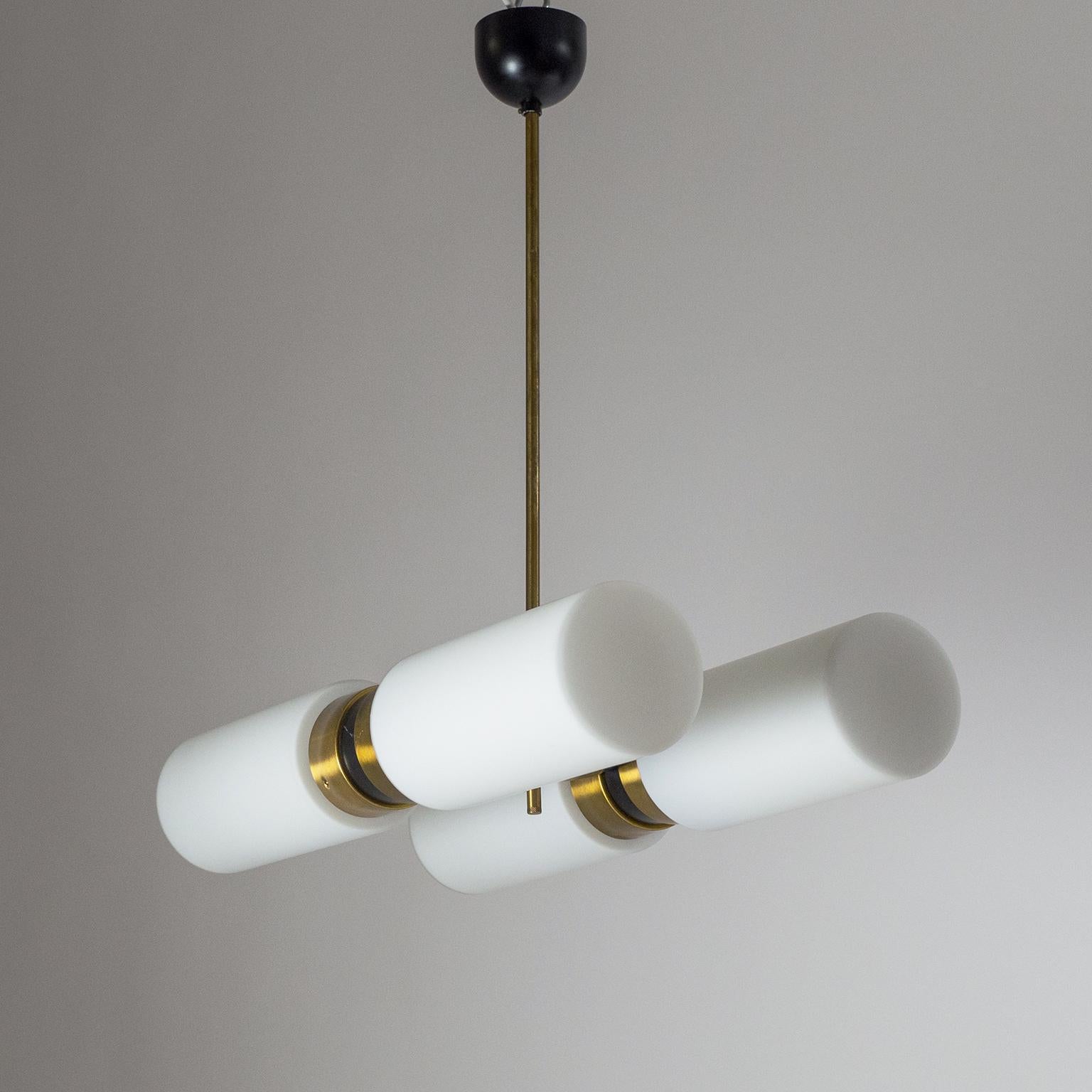 Excellent modernist satin glass and brass chandelier from the 1960s. Very sleek design paired with the timeless elegance of a brass, black and white color scheme. The glass diffusers are made of thick glass with a white inner casing and a satin