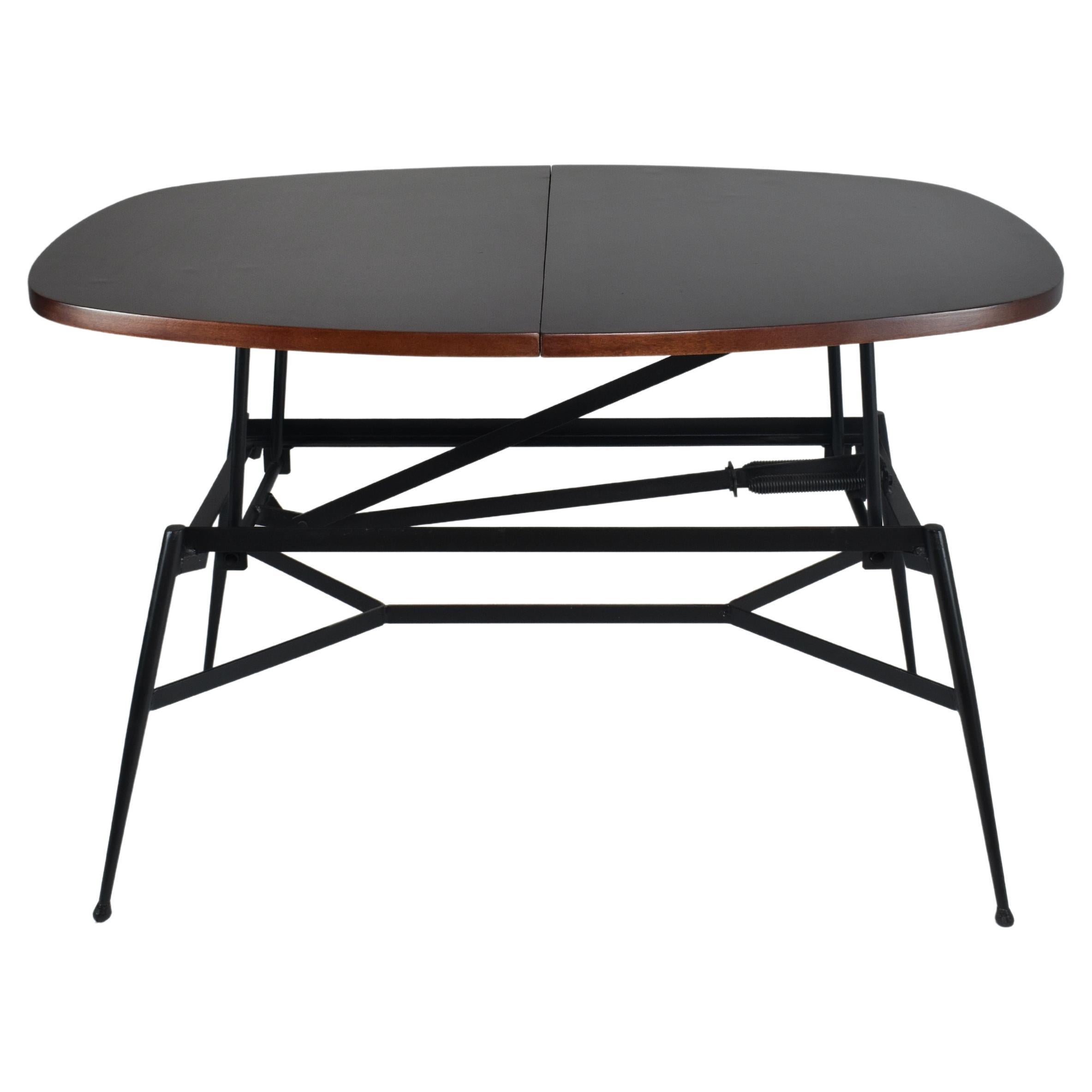 A masterfully restored 20th-century vintage Scandinavian adjustable coffee to dining table. The tabletop is composed of re-finished teak wood and the structure is in black lacquered steel. 
Circa 1960's
Measures: Width: 85,5 cm
Length: 111cm
Max
