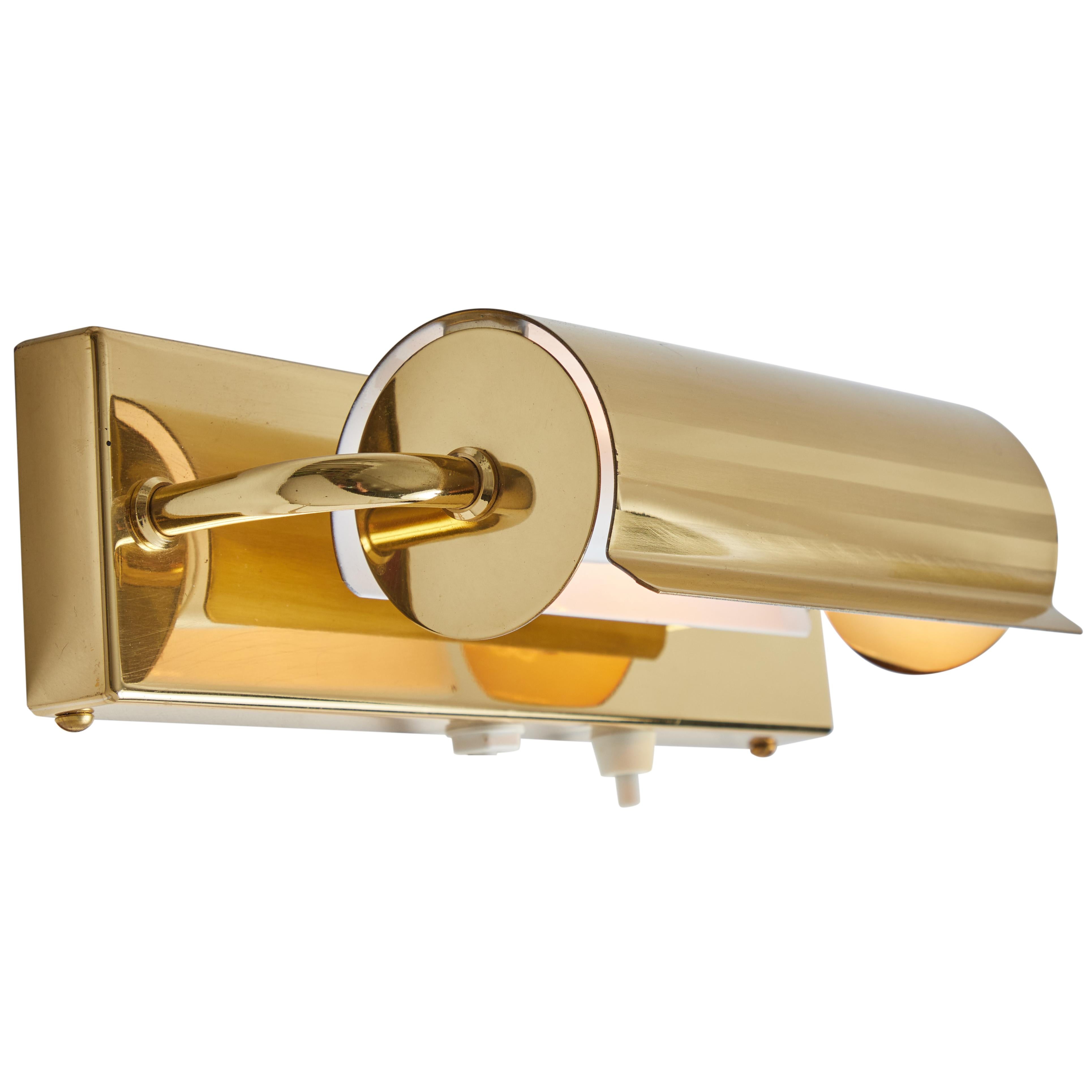 1960s Scandinavian brass rotating wall lamp in the Style of Charlotte Perriand. Produced in Scandinavia in the 1960s. A refined and elegant lamp executed in brass with a shade that rotates freely around the bulb. Reminiscent of the Charlotte