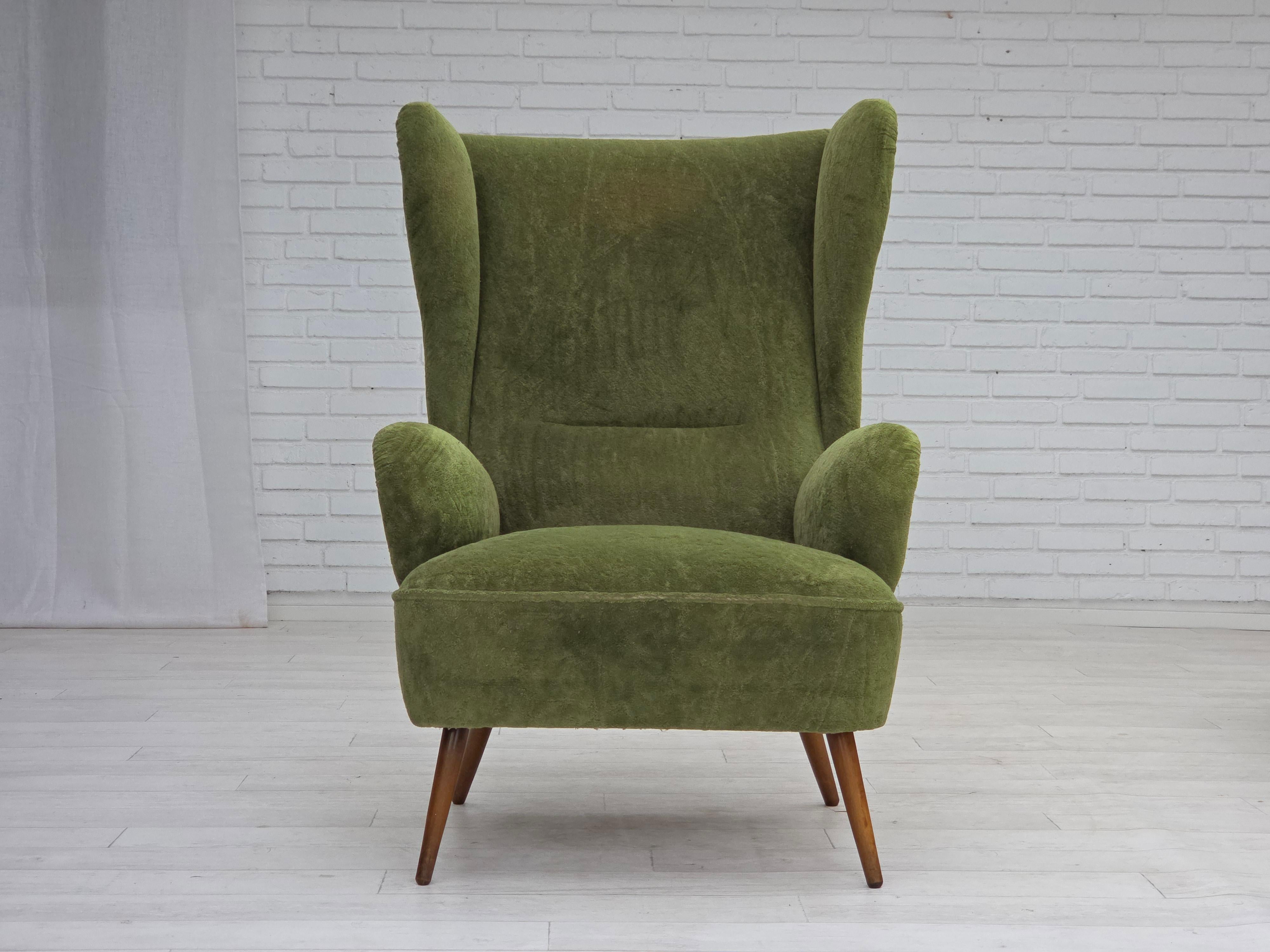 1960s, Scandinavian design. Highback armchair. Green furniture velour, beech wood legs, springs in the seat. The chair was reupholstered by craftsman about 10-15 years ago. Very good condition: no smells, no stains and stable construction.