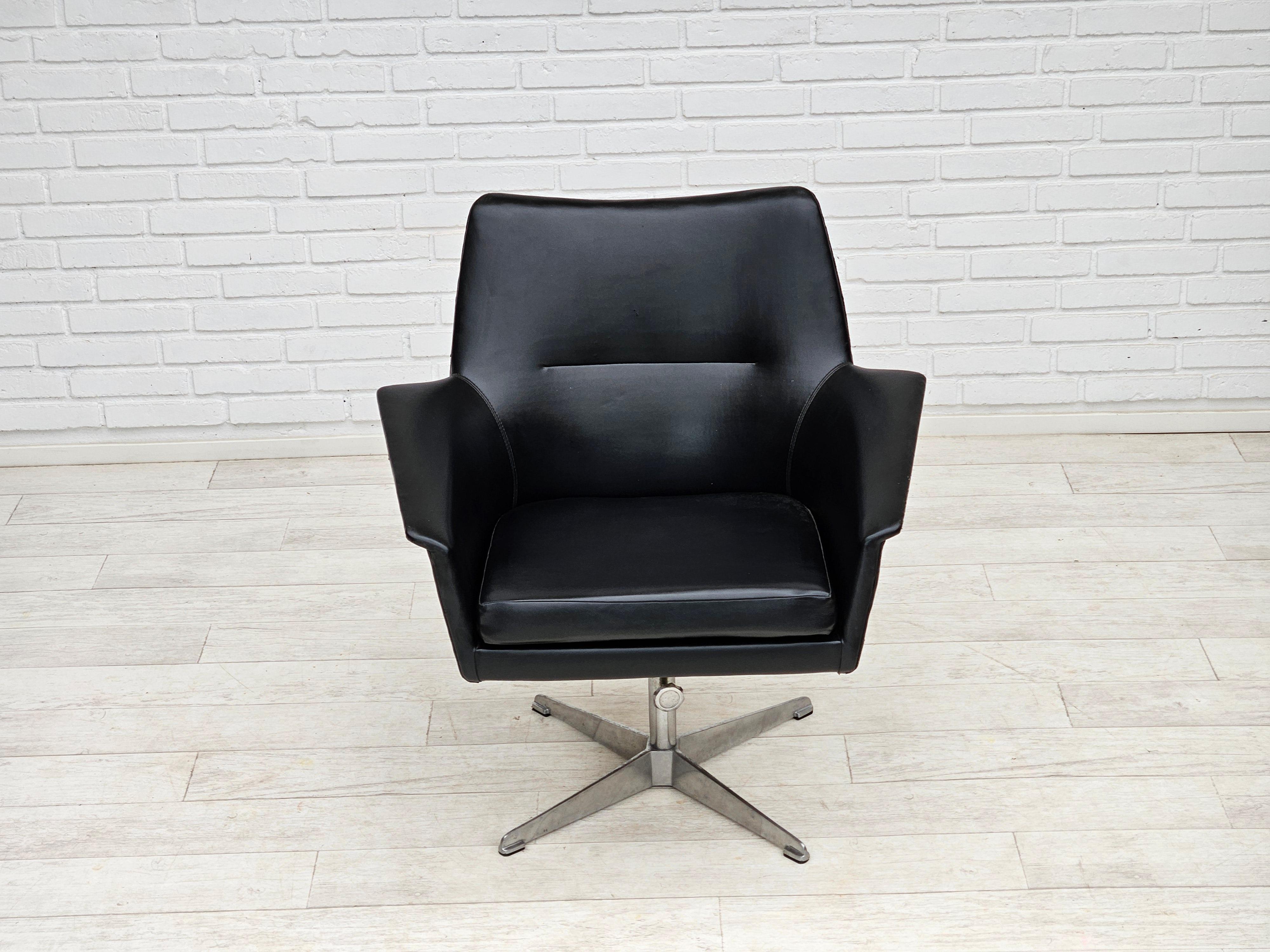 1960s, scandinavian design. Swivel chair in original good condition: no smells, no stains, signs of wear. Original black artificial leather, cast aluminum base. Manufactured by Danish or Swedish furniture maker in about 1965s. The chair was checked