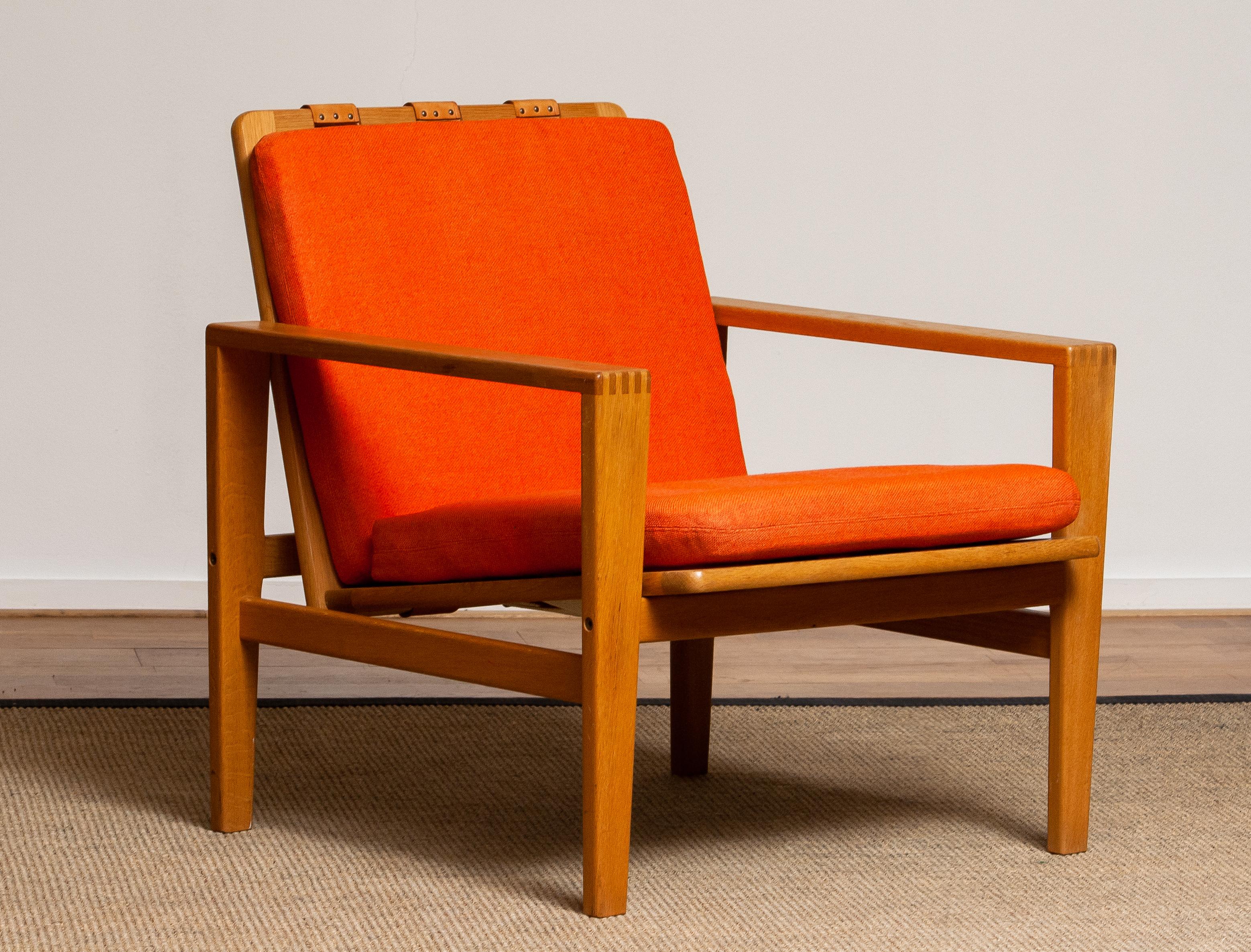 Comfortable Scandinavian lounge chair designed by Erik Merthen for Ire Skillingaryd Sweden, 1960s.
The oak frame is in perfect condition as well as the leather belts who supports the backrest. The cushions have been newly filled.
The overall