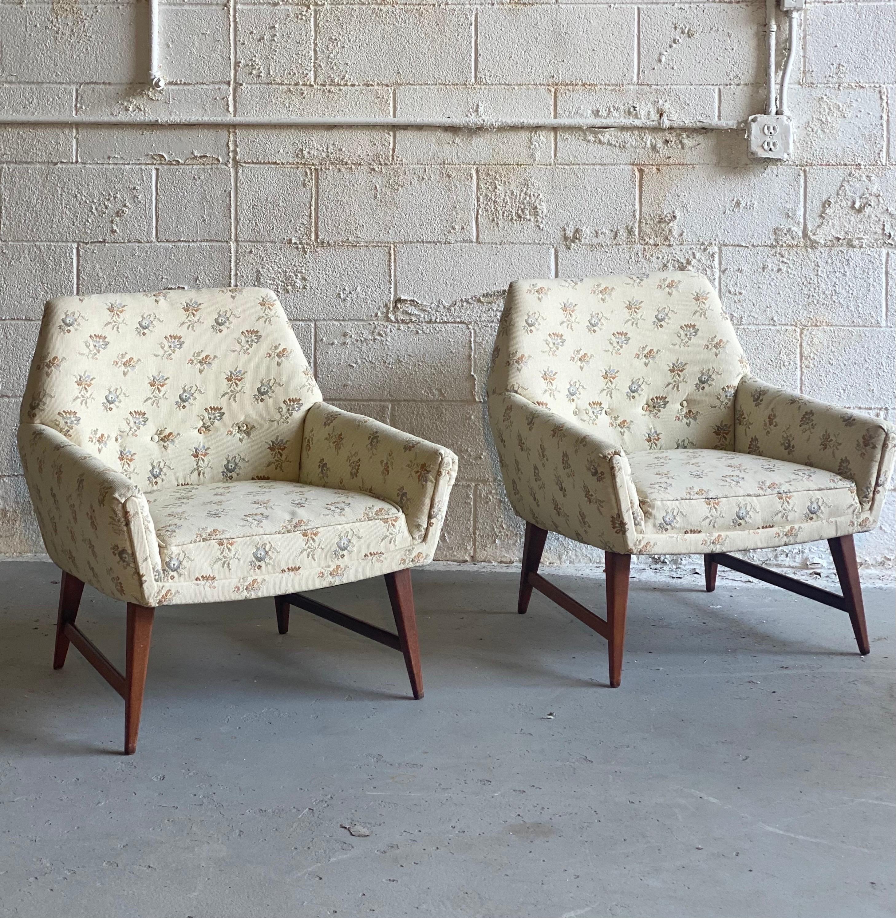 We are very pleased to offer a beautiful, Mid-Century Modern pair of chairs, circa the 1960s. True to its Scandinavian aesthetic, this pair is characterized by its simplicity and functionality. Clean lines are notorious in its wraparound upholstered