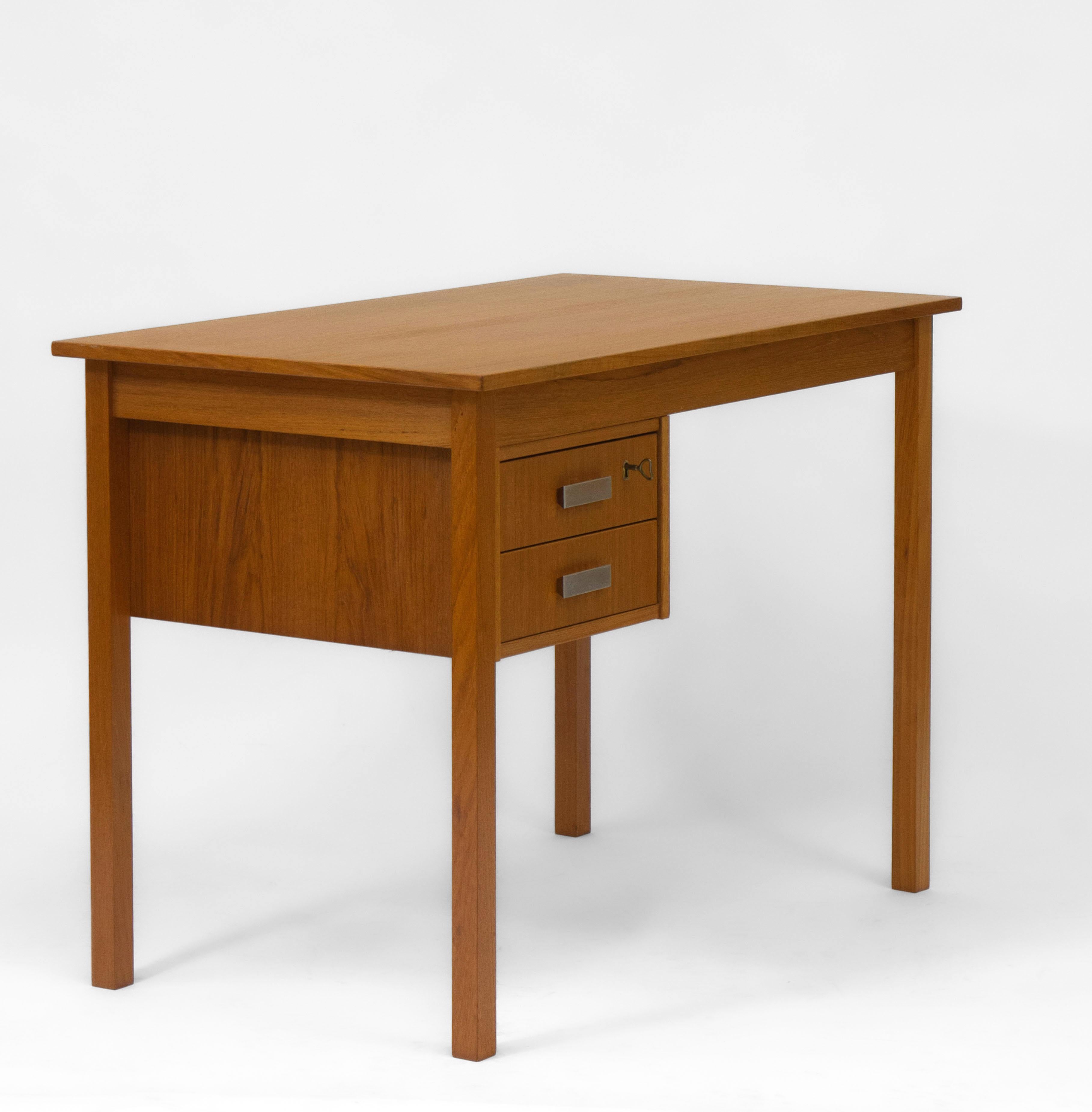 Scandinavian mid century teak desk with contrasting aluminium faced drawer handles. Circa 1960s.

The desk is in very good clean condition, showing very light wear. There is no damage. A very slightly darker patch to the back right hand side of