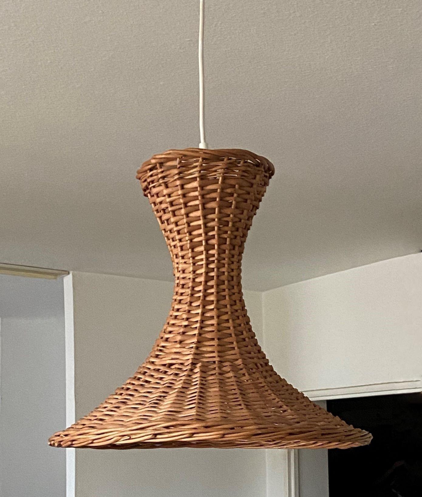 Mid-century rattan pendant, Denmark, 1960s. This beautiful suspension lamp is entirely handcrafted in rattan with unsual design provinding a warm and pleasant light. The pendant is in fine vintage condition, no damages, rewired. It takes one large