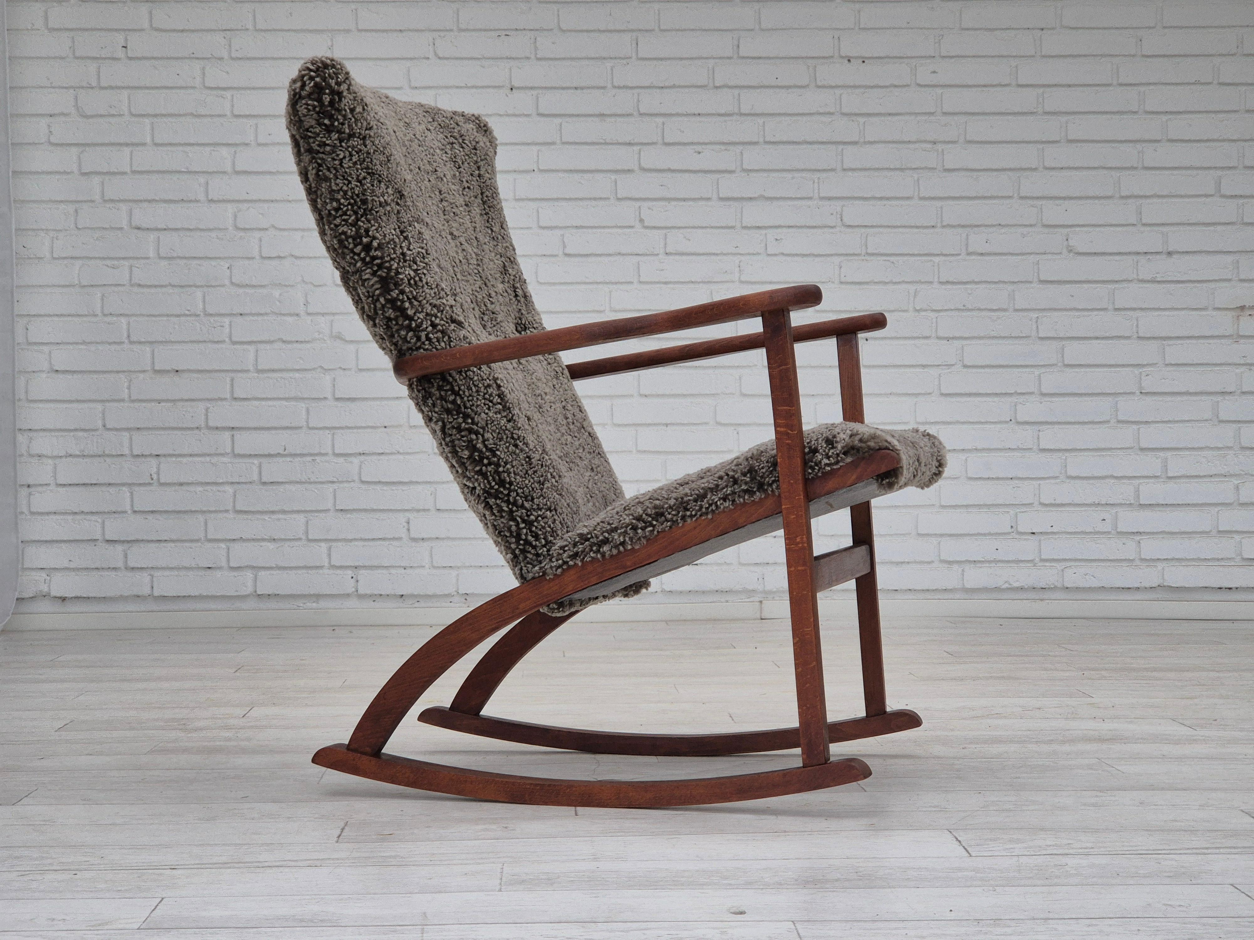 1960s, Scandinavian rocking chair. Reupholstered in quality New Zealand genuine sheepskin 