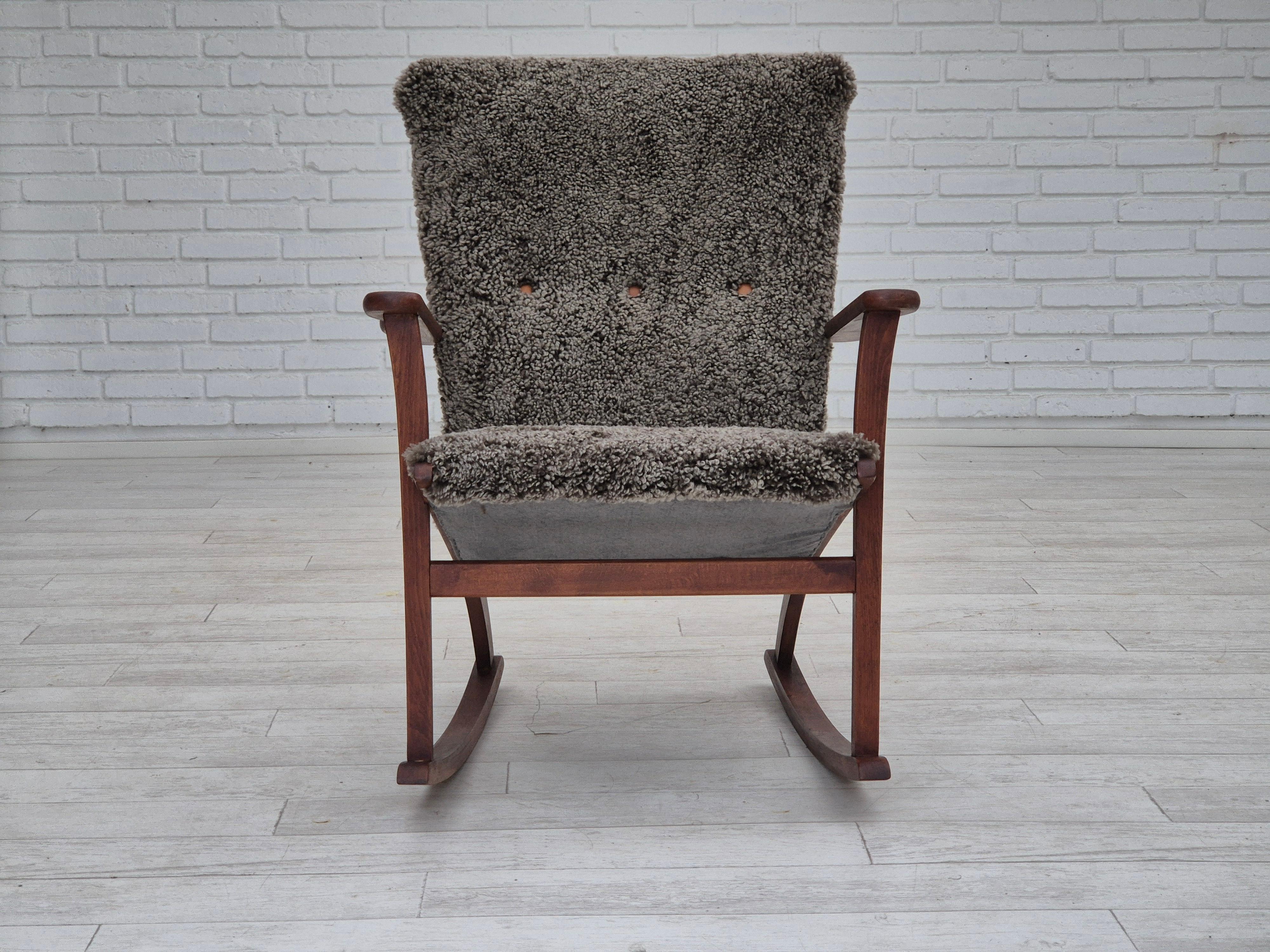 Scandinavian Modern 1960s, Scandinavian rocking chair, reupholstered in quality genuine sheepskin.