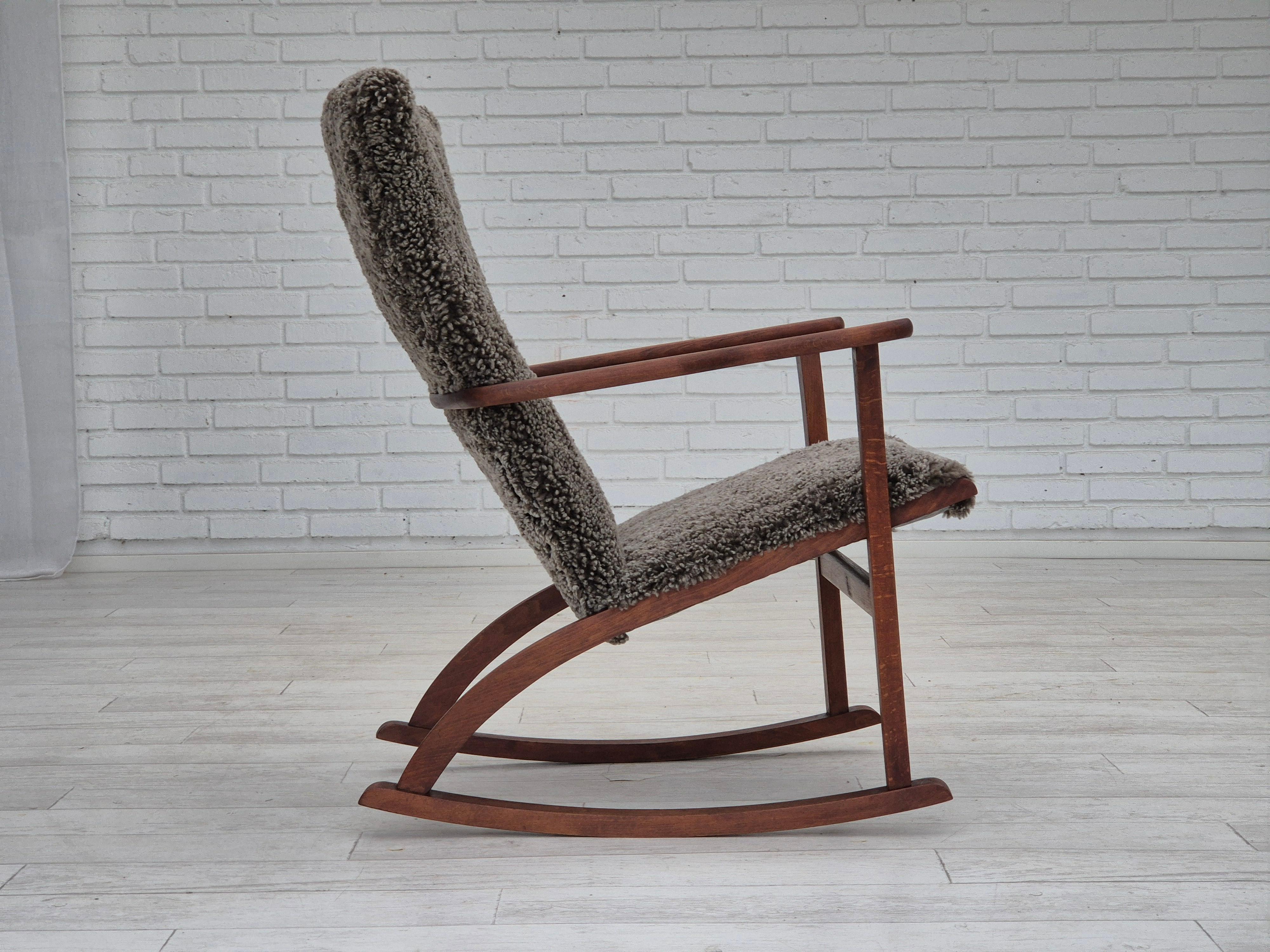 Danish 1960s, Scandinavian rocking chair, reupholstered in quality genuine sheepskin.