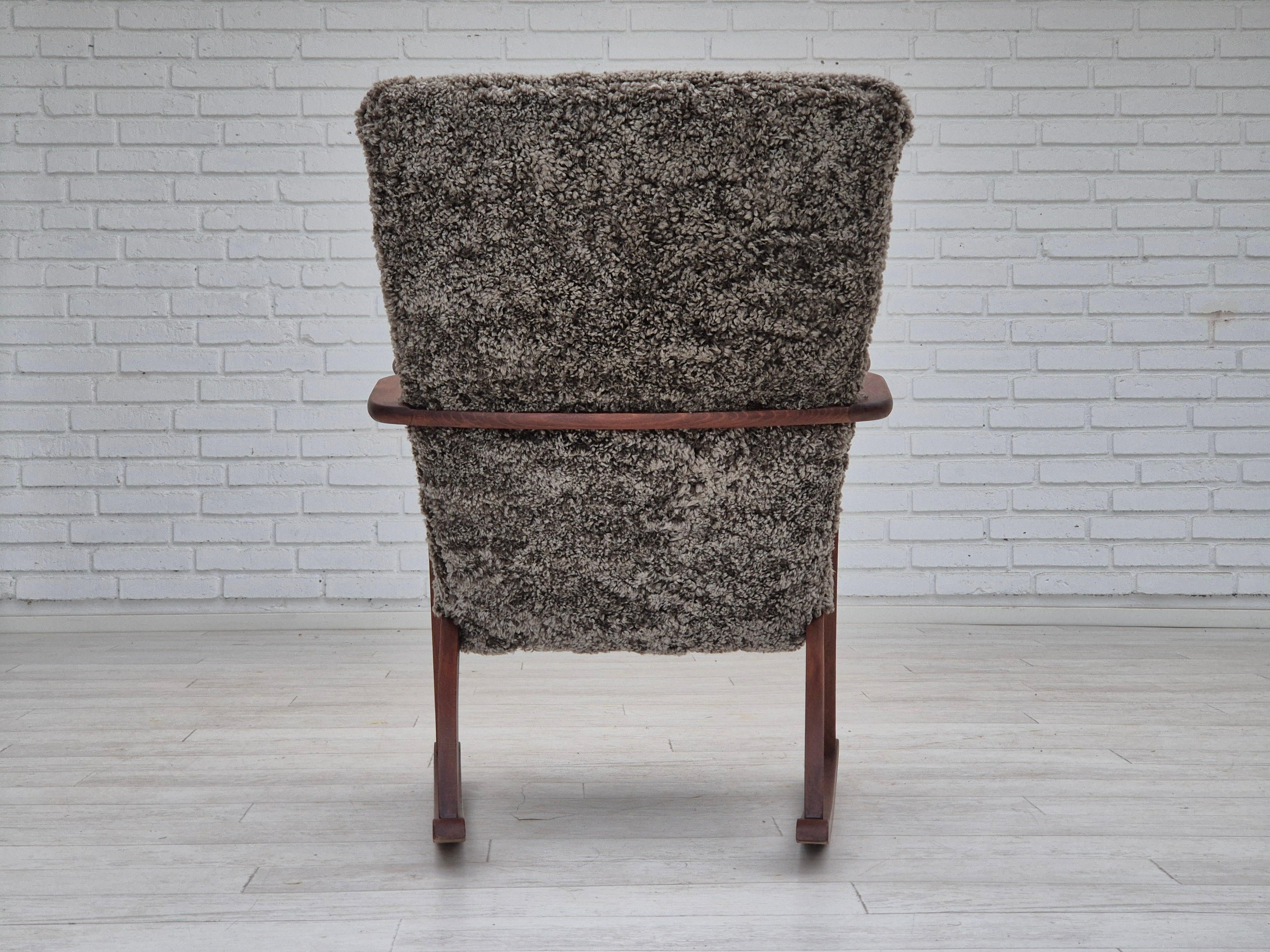 1960s, Scandinavian rocking chair, reupholstered in quality genuine sheepskin. In Good Condition In Tarm, 82