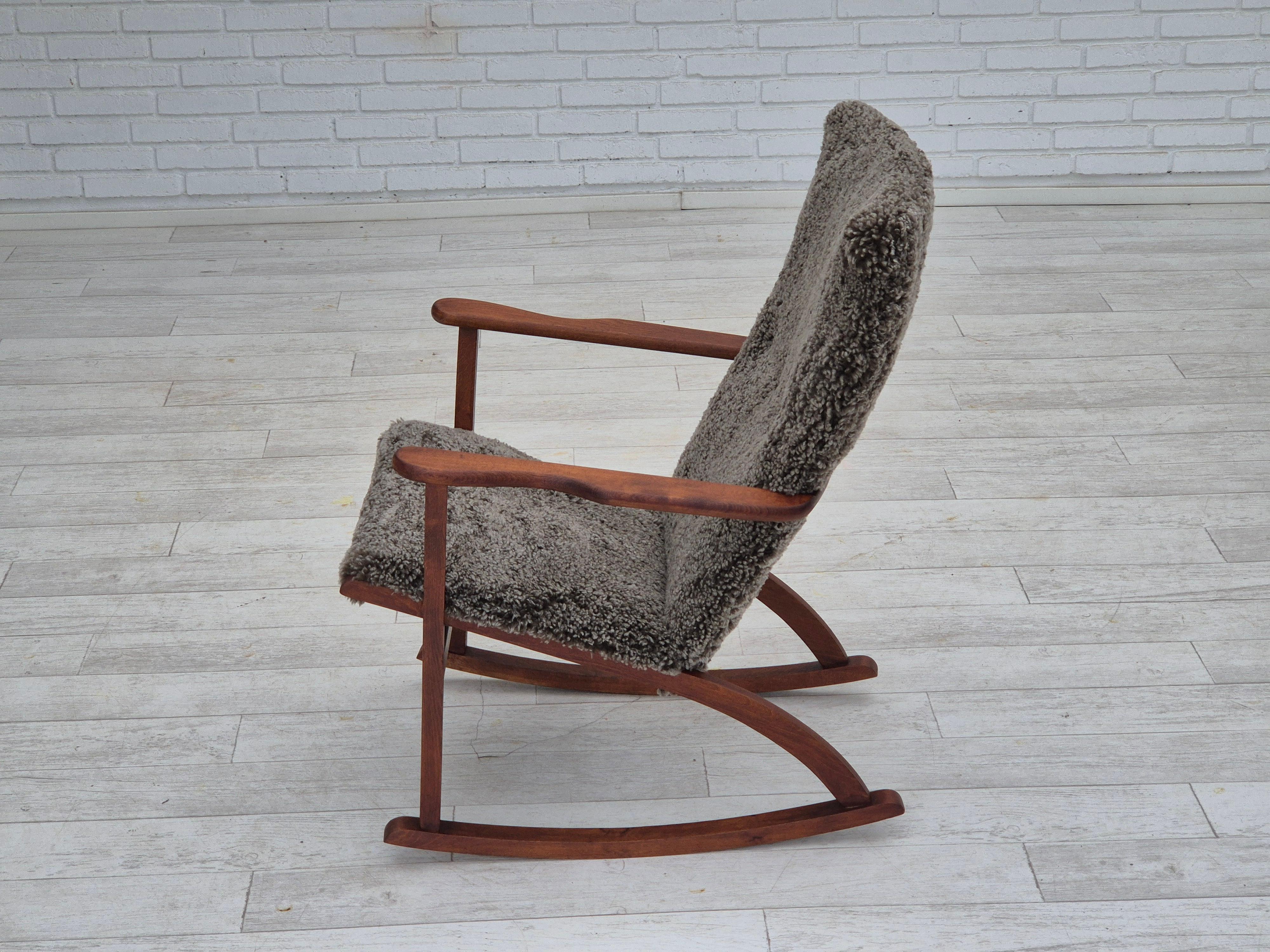Mid-20th Century 1960s, Scandinavian rocking chair, reupholstered in quality genuine sheepskin.
