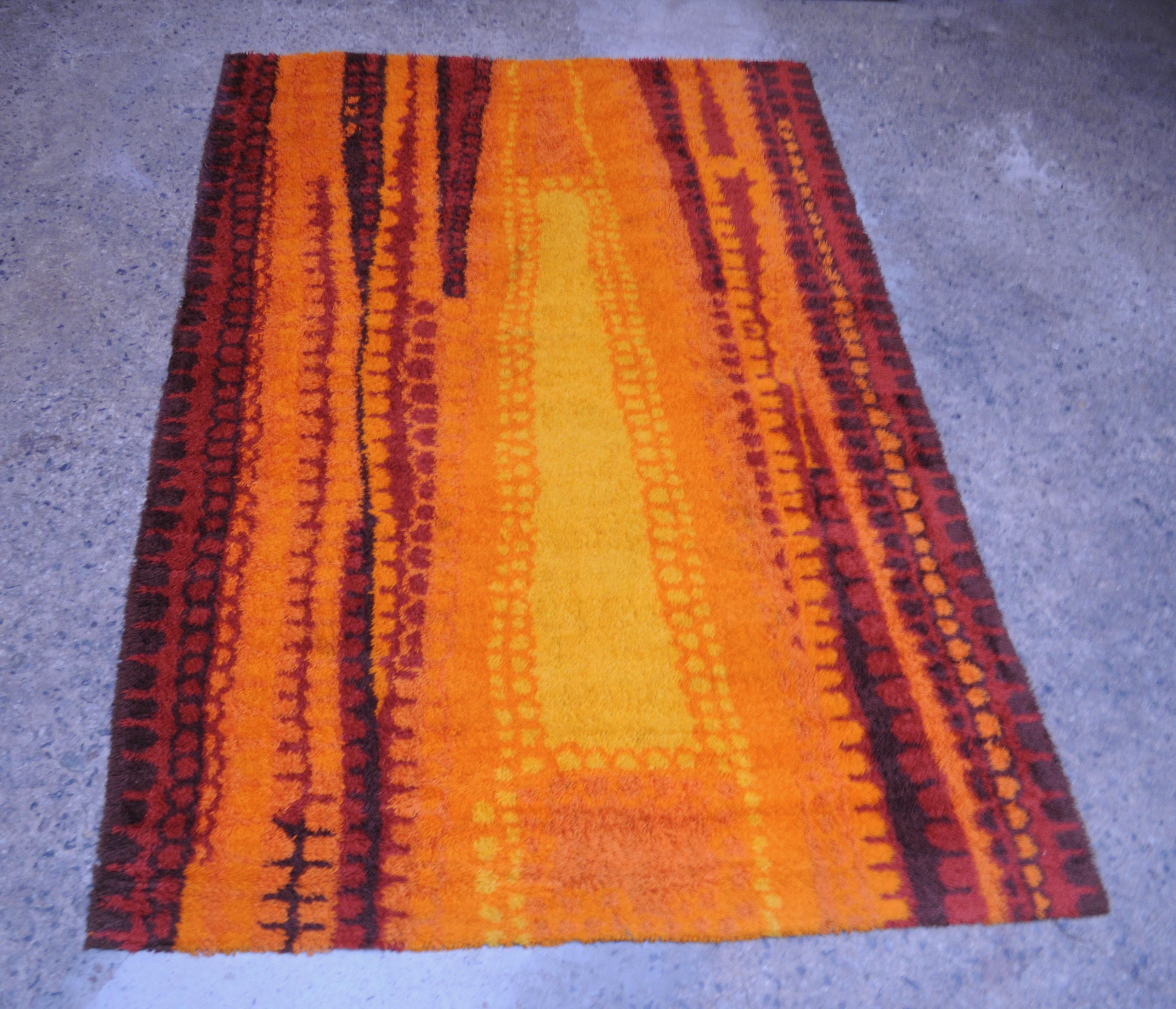 Long, vibrant Rya in orange, yellow, red, and brown. Wonderful texture and abstract lines artfully woven into the high pile. Expertly cleaned and in very good, vintage condition (there is some light strand loss around the yellow swath, as shown) .