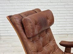 Anni '60, poltrona girevole scandinava, rivestita in pelle marrone.