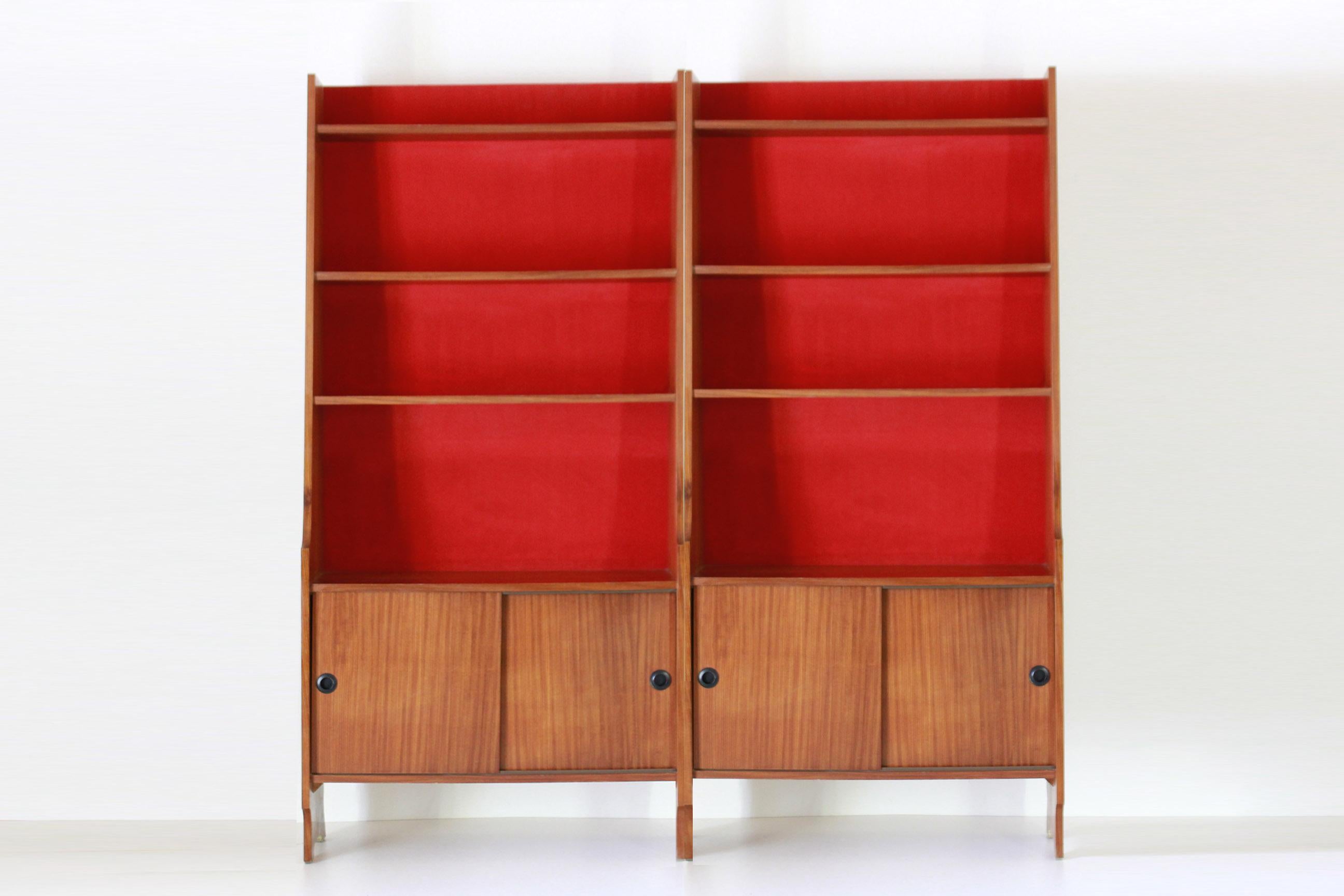 A 1960s vintage modular bookcase with teak and red velvet structure.Two units available, Classic italian midcentury modern style. Sliding case at the bottom of each module. Price to be meant per each unit.

In very good conditions with only few