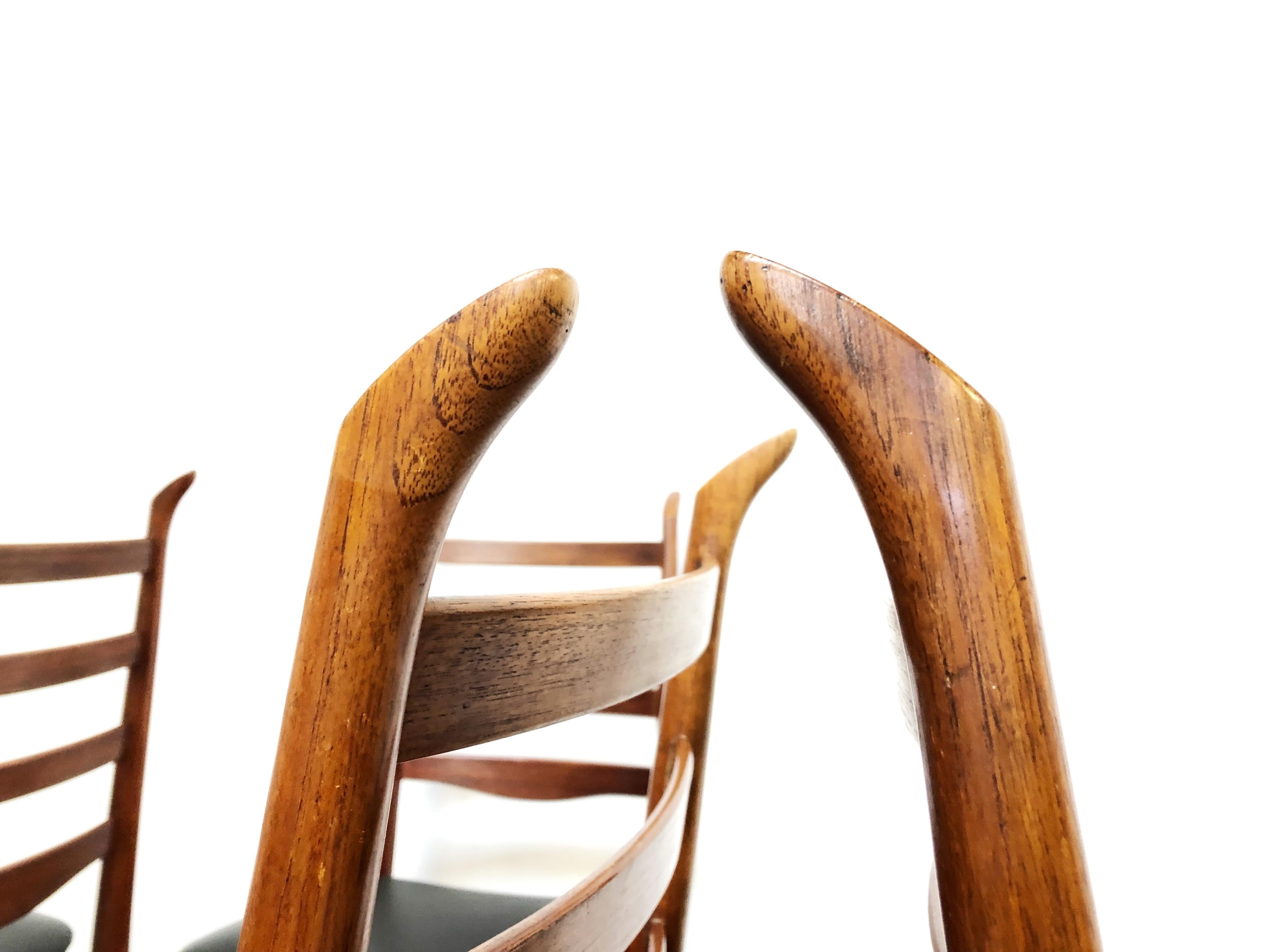 Four Danish dining chairs by Scantic Mobelvarerk. 

Featuring antler points to the ladder back supports.

Teak with black vinyl seats.

Price for all four.