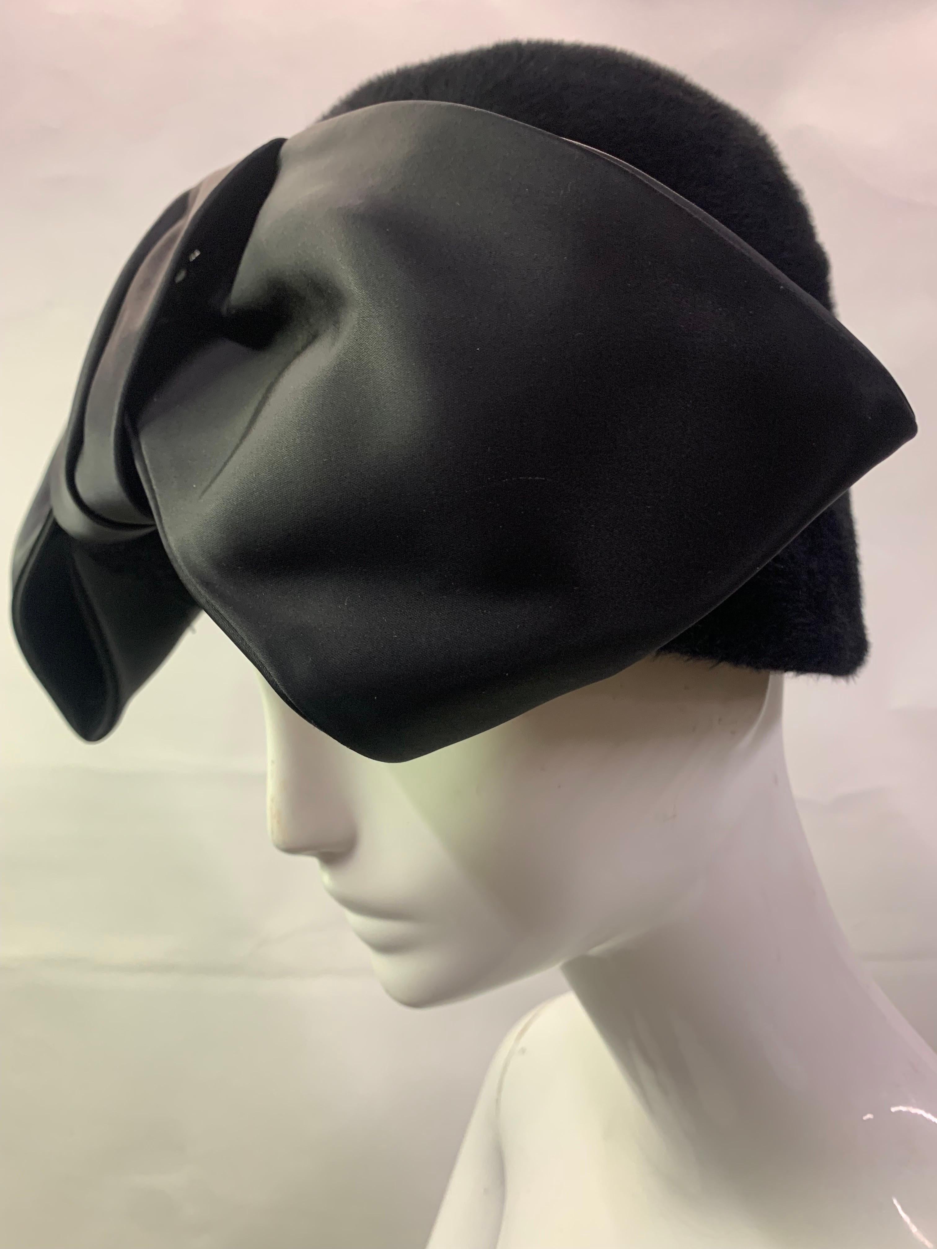1960s Schiaparelli Black Wool Felt Cloche Hat w Huge Silk Bow At Front.  A striking homage to the classic 1920s style this plush and furry cloche is as stunning today as ever with its show-stopping, oversized matte silk bow!   Size Medium-Large. 