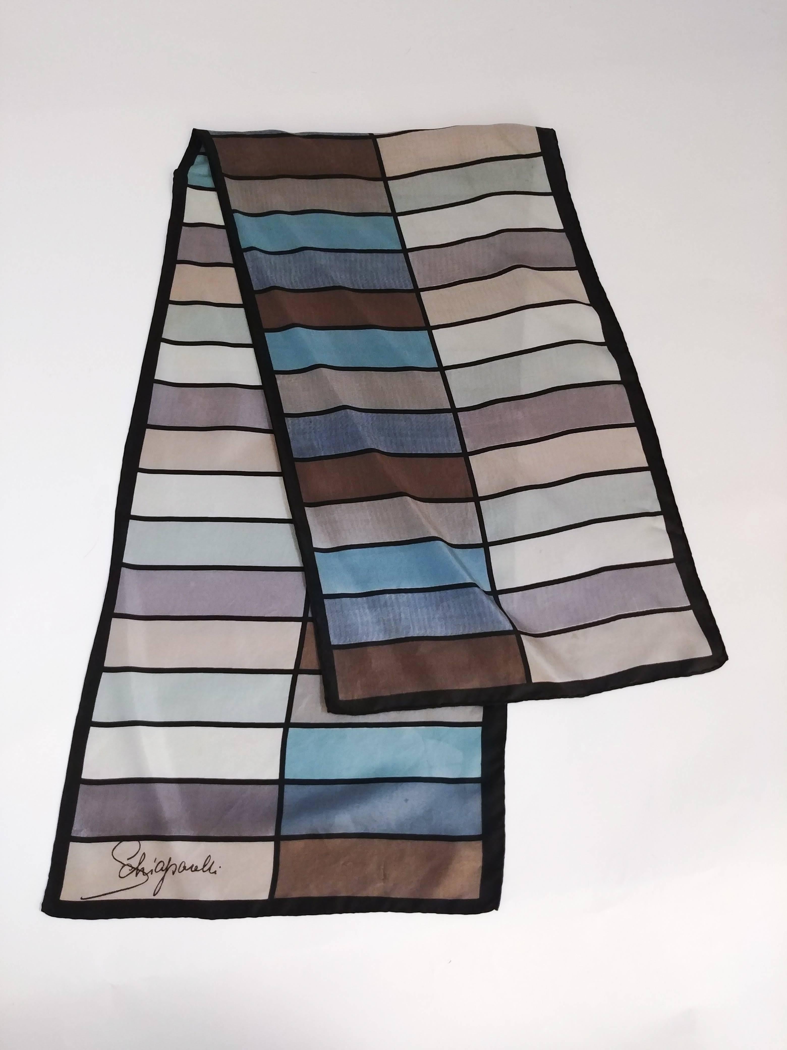 1960s Schiaparelli Grey & Blue Geometric Scarf. Rectangle shaped silk scarf with hand-rolled edges and multicolored rectangle print.