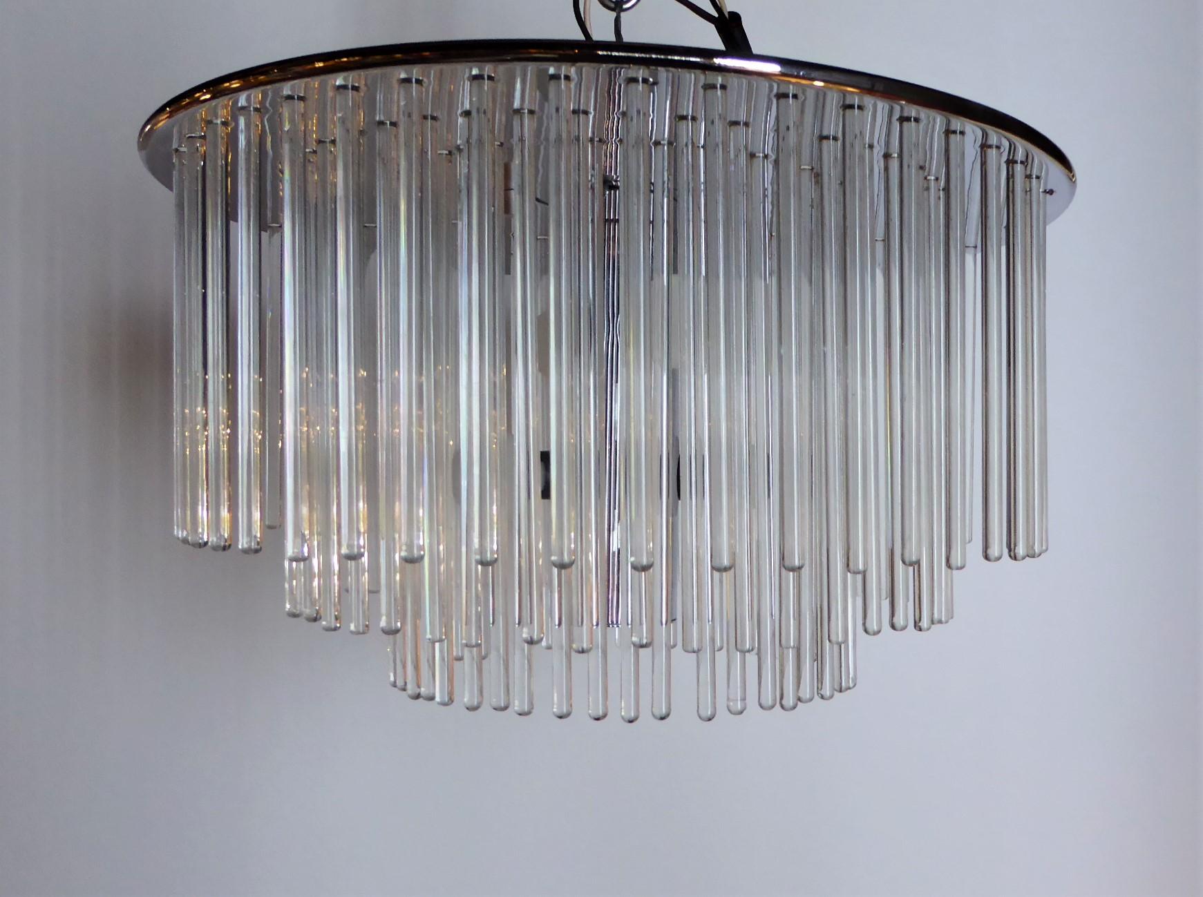 An elegant flushmount with four candelabra lights behind 144 blown glass crystal rods in a three tier form. Designed by Gaetano Sciolari and imported from Italy by Lightolier, this lamp has a presence and elegance wherever used. The fixture in