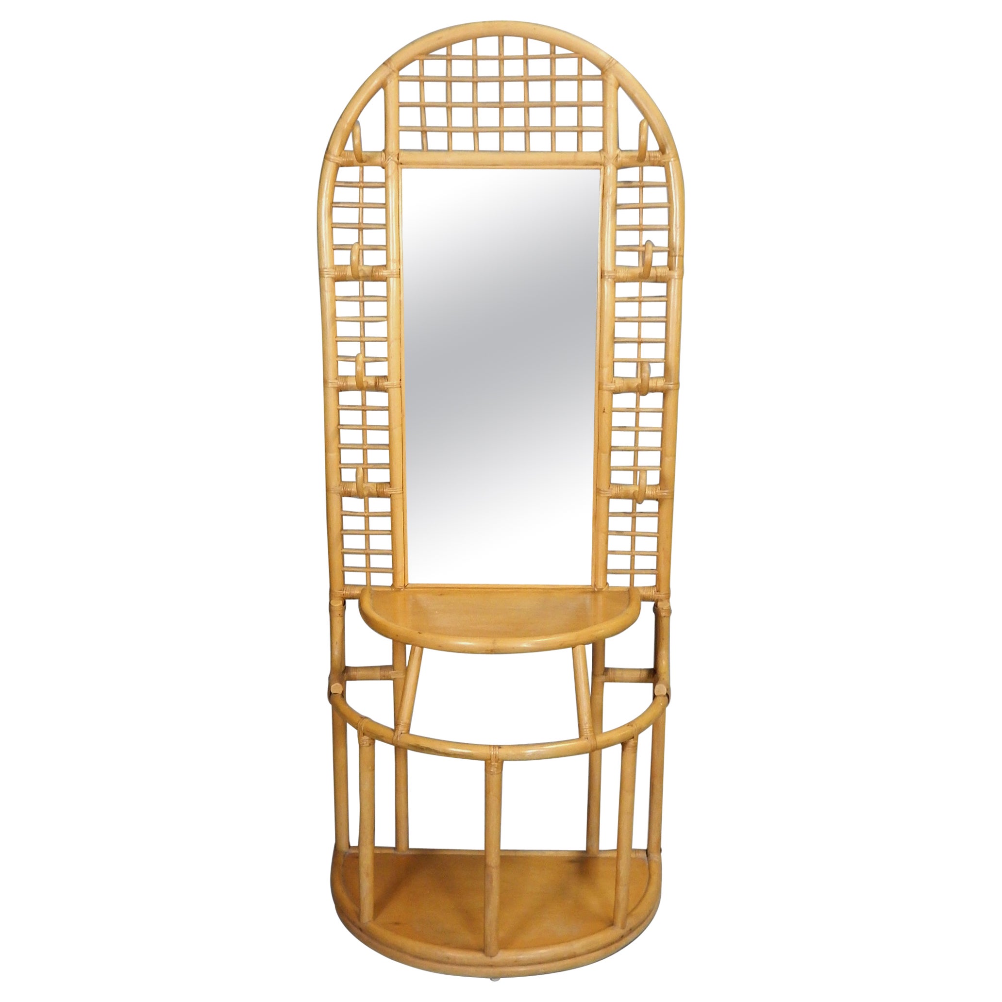Exceptionally well crafted Rattan hall tree/coat rack and mirror.
Hand sculpted in the Philippines, circa 1960.
This piece is completely original and in excellent condition.
No damage or repairs. Finish is also original. 
Stands over 6 feet