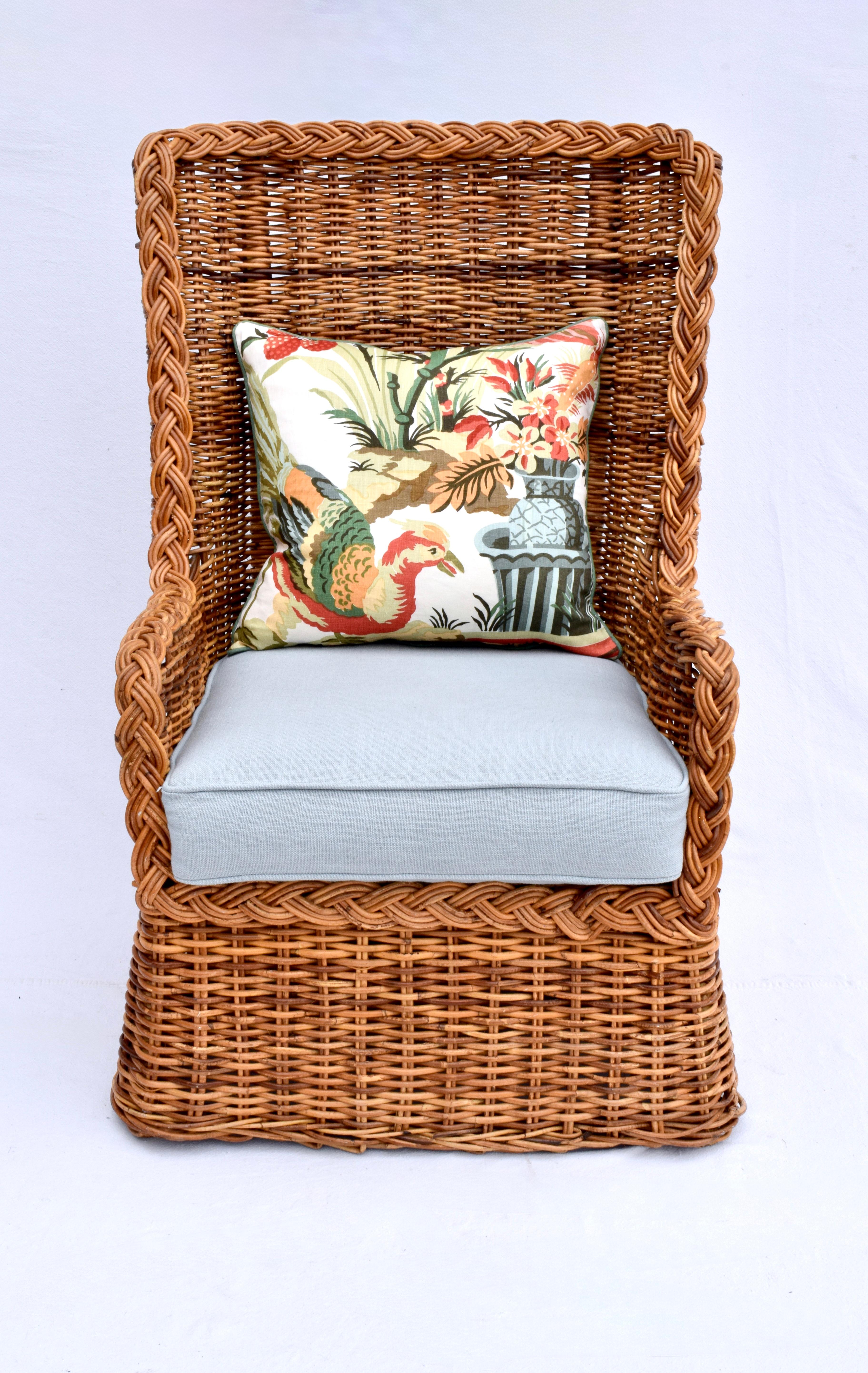 A unique braided wicker Rattan wingback chair & ottoman set with new custom cushions embellished with vintage hand block print linen with goose down filled back cushion; never used in new condition. Attributed to Michael Taylor for Baker. Seat:
