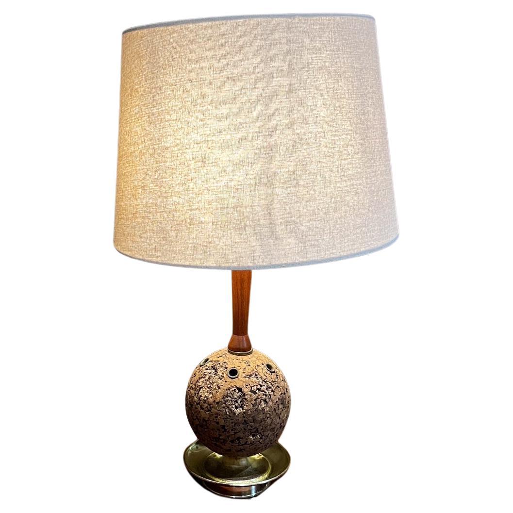 1960s Sculptural Cork and Walnut Table Desk Lamp
Brass Base unmarked attributed Laurel Lamp Co
14.5 x 5.5 diameter
Brass plated steel, cork and walnut wood. 
Round circle at top, decorative or as pen holder.
Original vintage unrestored condition.