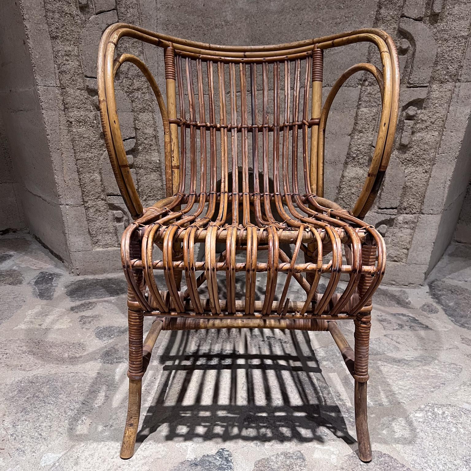 1960s refined rattan midcentury wicker patio lounge chair 
Robert Wengler of Denmark
renowned master craftsman of wicker
29 h x 20 d x 21.5 w Seat h 14.75
preowned original unrestored vintage condition.
Please refer to our images.
Delivery to LA OC