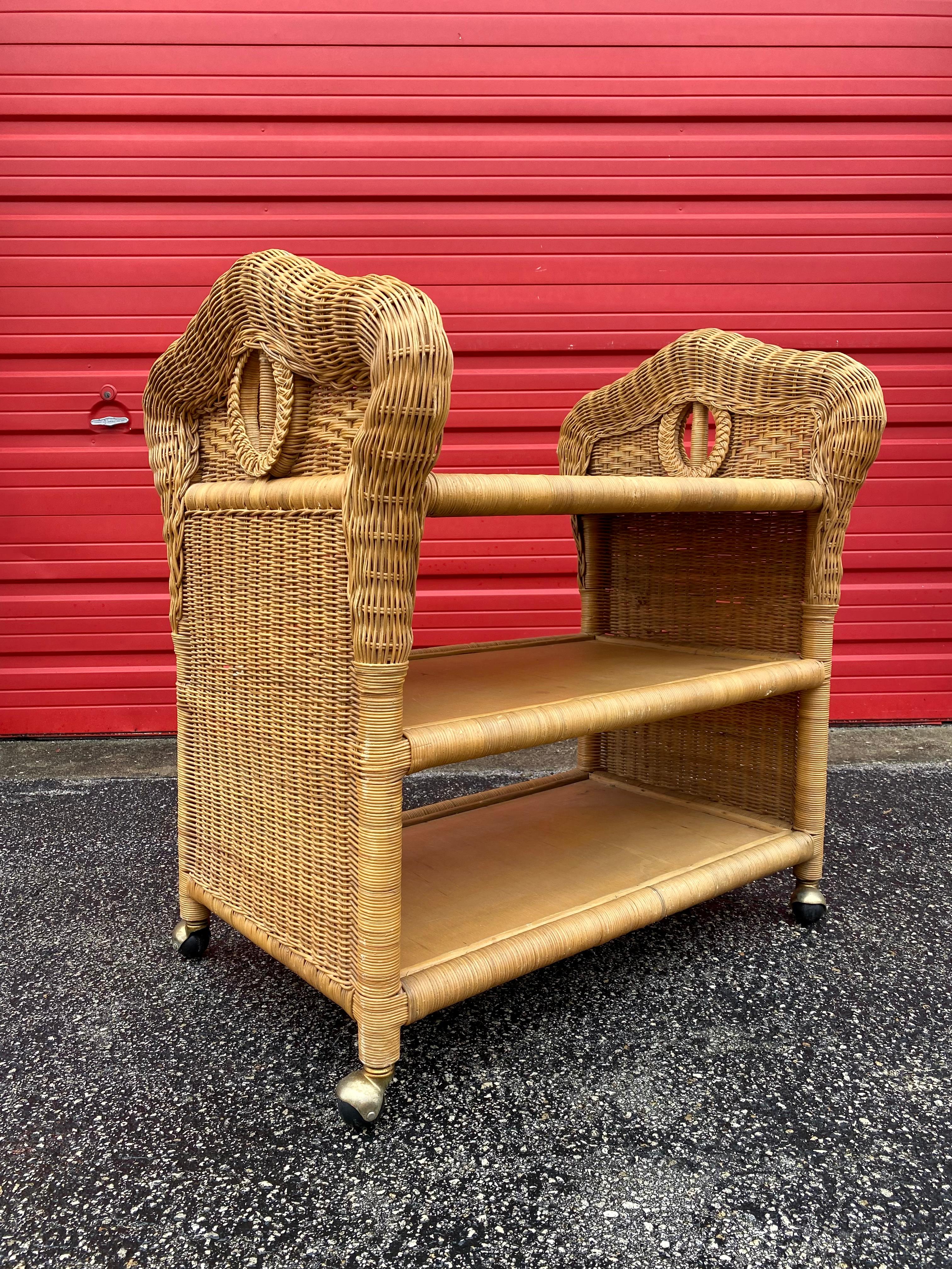 The rare woven sculptural rattan cart is statement piece which is also extremely comfortable and packed with personality! Just look at the gorgeous design on this beauty!  Mid-Century Modern wicker, rattan serving trolley, bar cart or tray table on