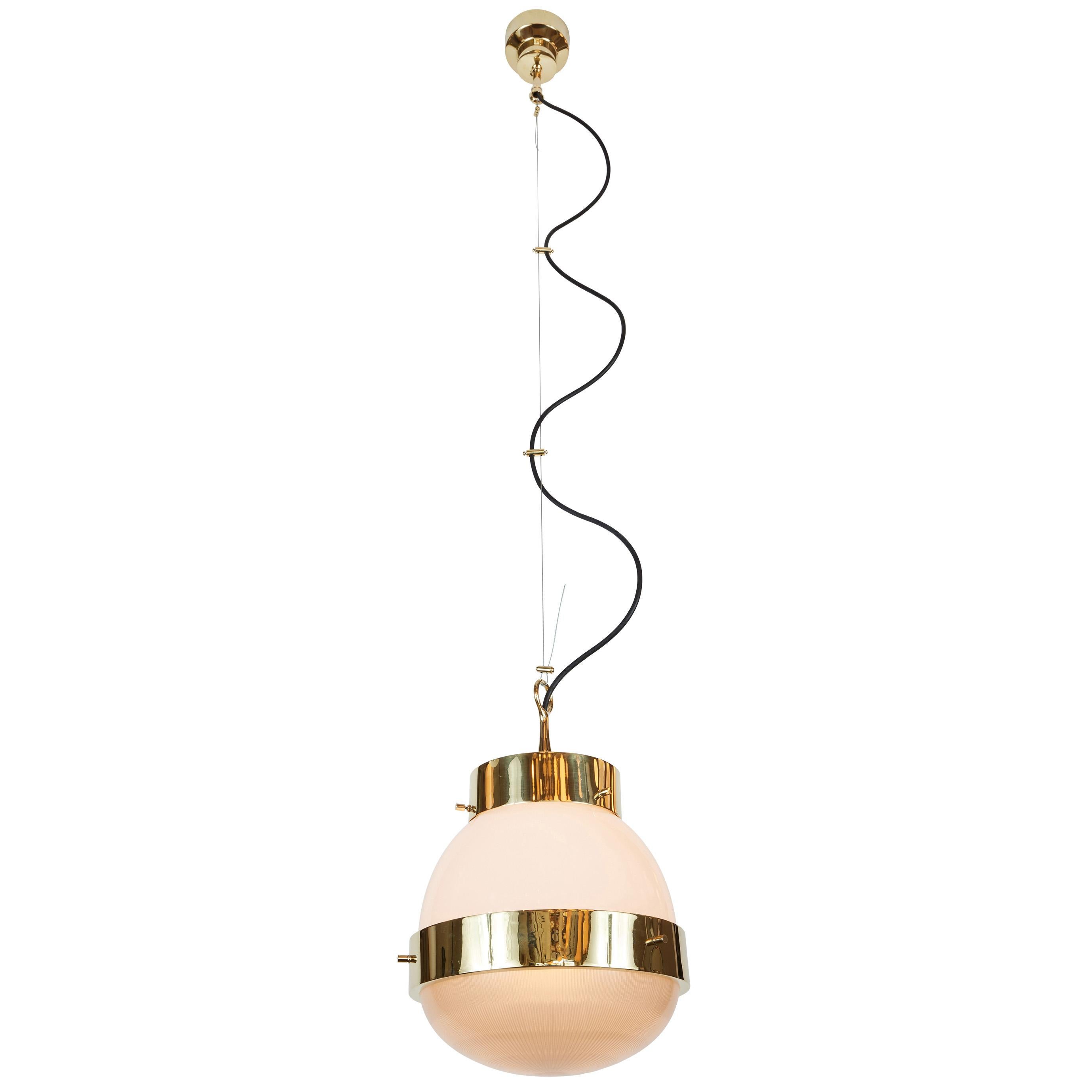 1960s Sergio Mazza 'Delta' pendants for Artmeide. Executed in polished brass, opaline and pressed glass. An incredibly warm and refined design from one of Italy's most illustrious midcentury icons. 

Price is per item. Two lamps available.

Born in