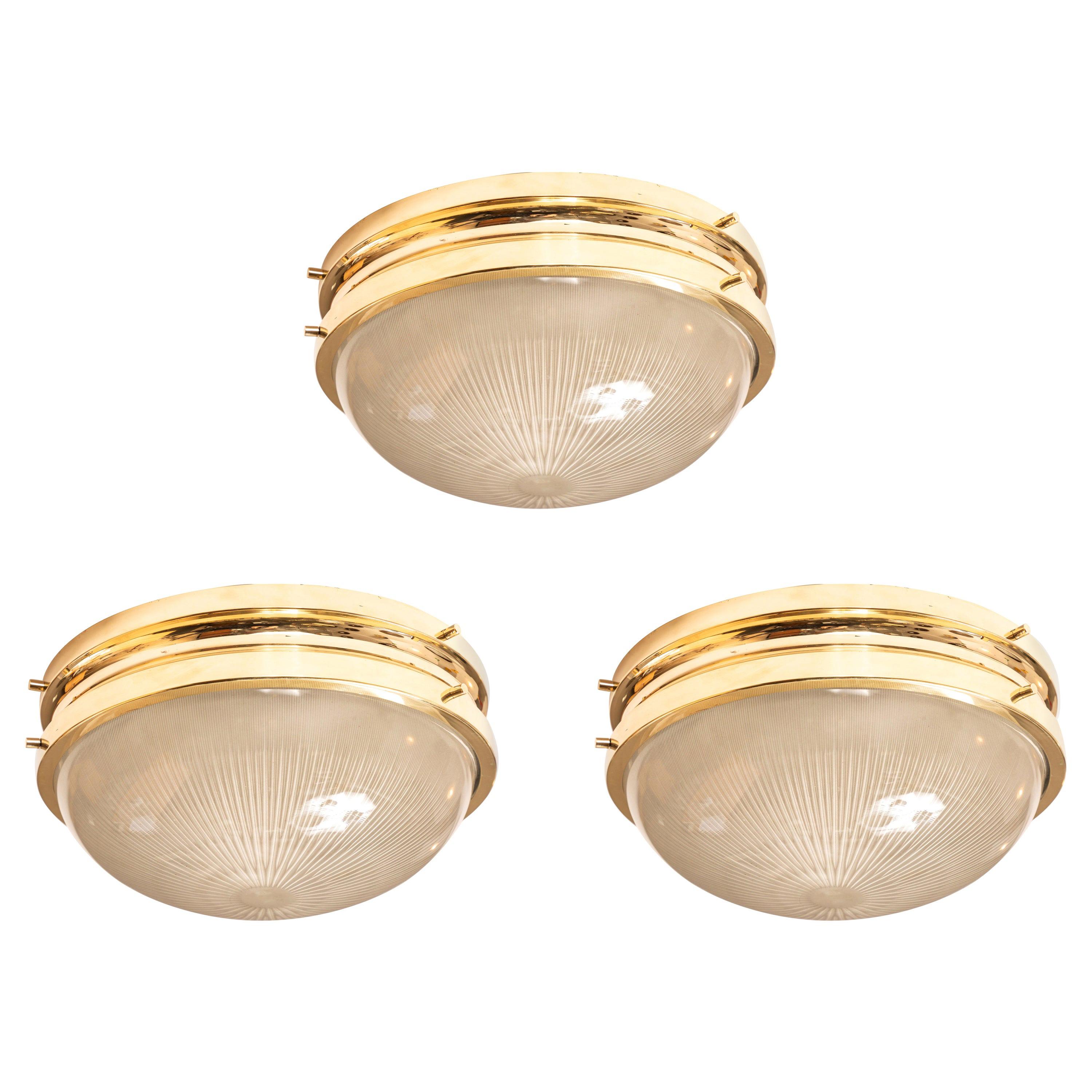 1960s Sergio Mazza brass 'Sigma' wall or ceiling lights for Artemide. Executed in polished brass and pressed opaline glass by Sergio Mazza for Artemide, Italy, circa 1960s. Professionally rewired for US electrical and accommodates two standard