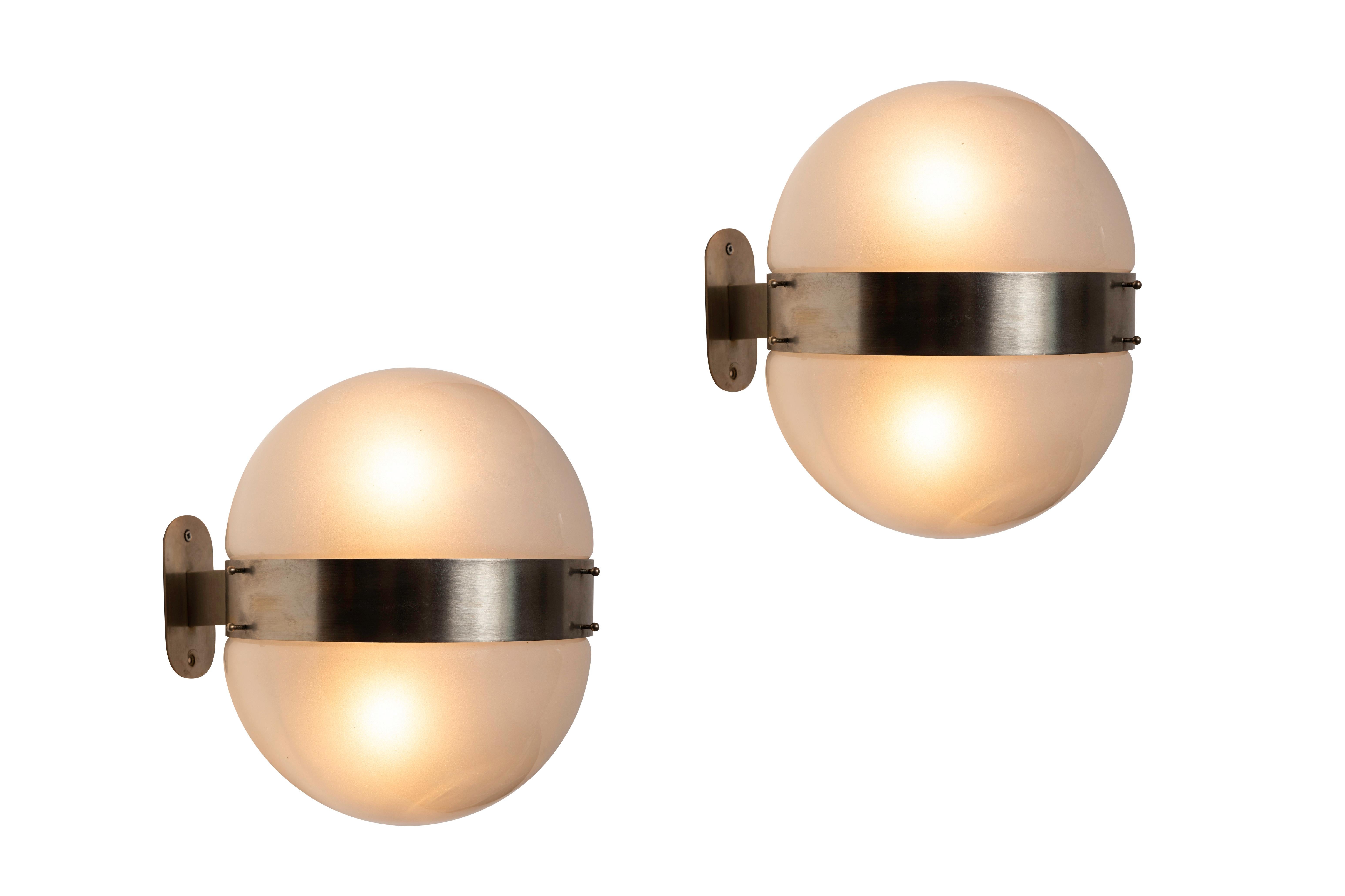 1960s Sergio Mazza 'Clio' sconce for Artemide. Executed in nickeled brass and opaline glass, Italy, circa 1960s. Clean and architectural, these hardwired sconces emit a pleasingly filtered light through its double glass shades.

Price is per item. 2