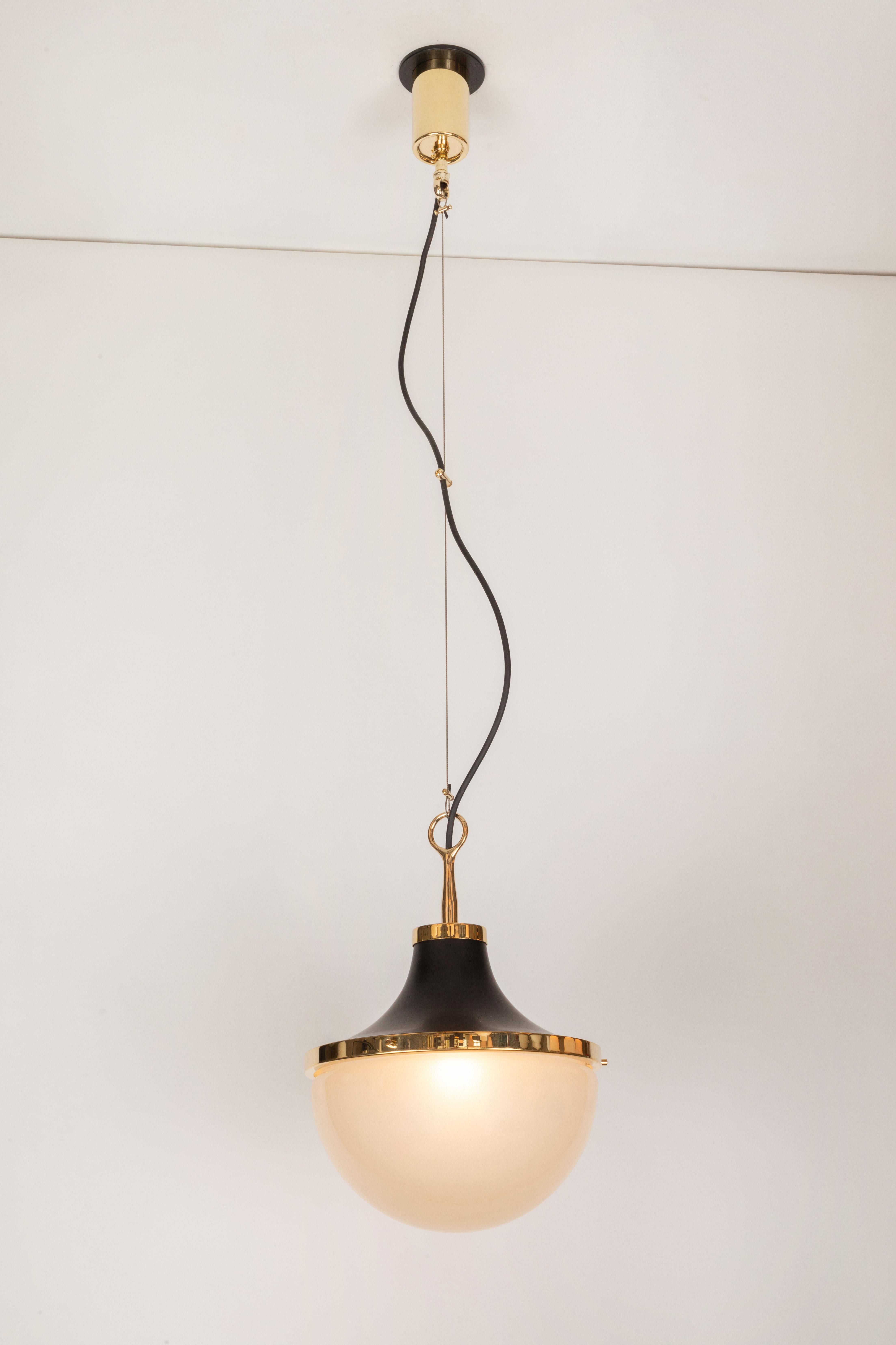 1960s Sergio Mazza 'Pi' pendant in brass and black metal for Artemide. Executed in black painted metal, polished brass and opaline glass, Italy, circa 1962. Height can be adjusted by several inches.

Born in Italy in 1931, Sergio Mazza created