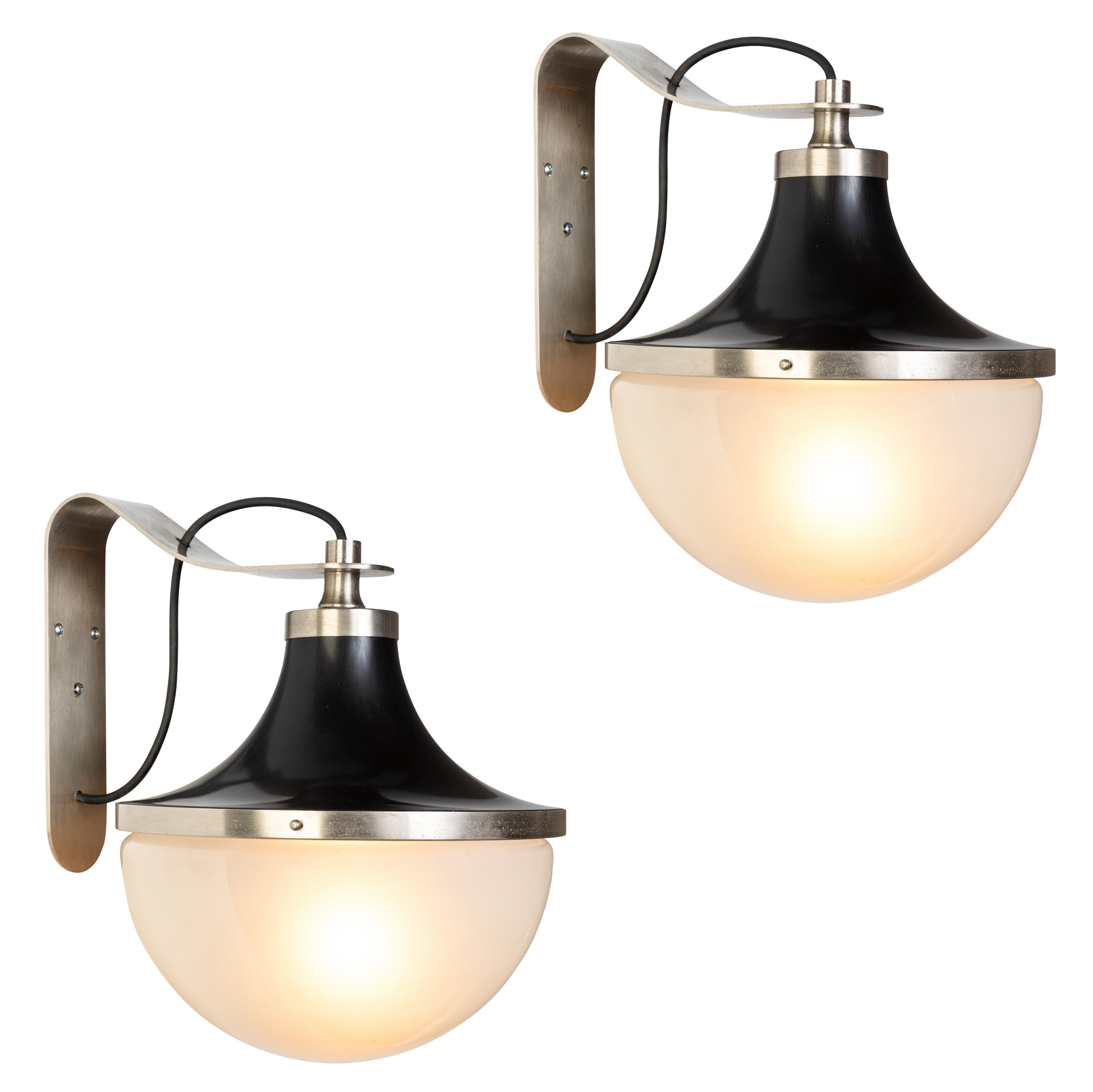 1960s Sergio Mazza 'Pi' wall lights for Artemide. Executed in nickeled brass, black painted metal and Opaline glass. Architectural and incomparable, these sconces emit a pleasingly filtered light through its beautiful glass shade.

Price is per