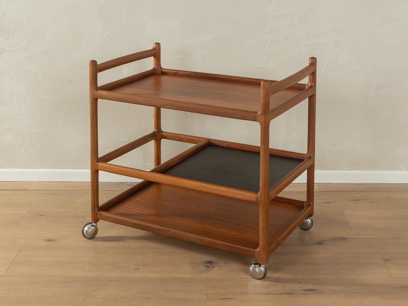 Classic serving trolley from the 1960s by Johannes Andersen for CFC Silkeborg. Solid teak frame with three shelves in teak veneer and metal castors.

Quality Features:

    accomplished design: perfect proportions and visible attention to detail
   