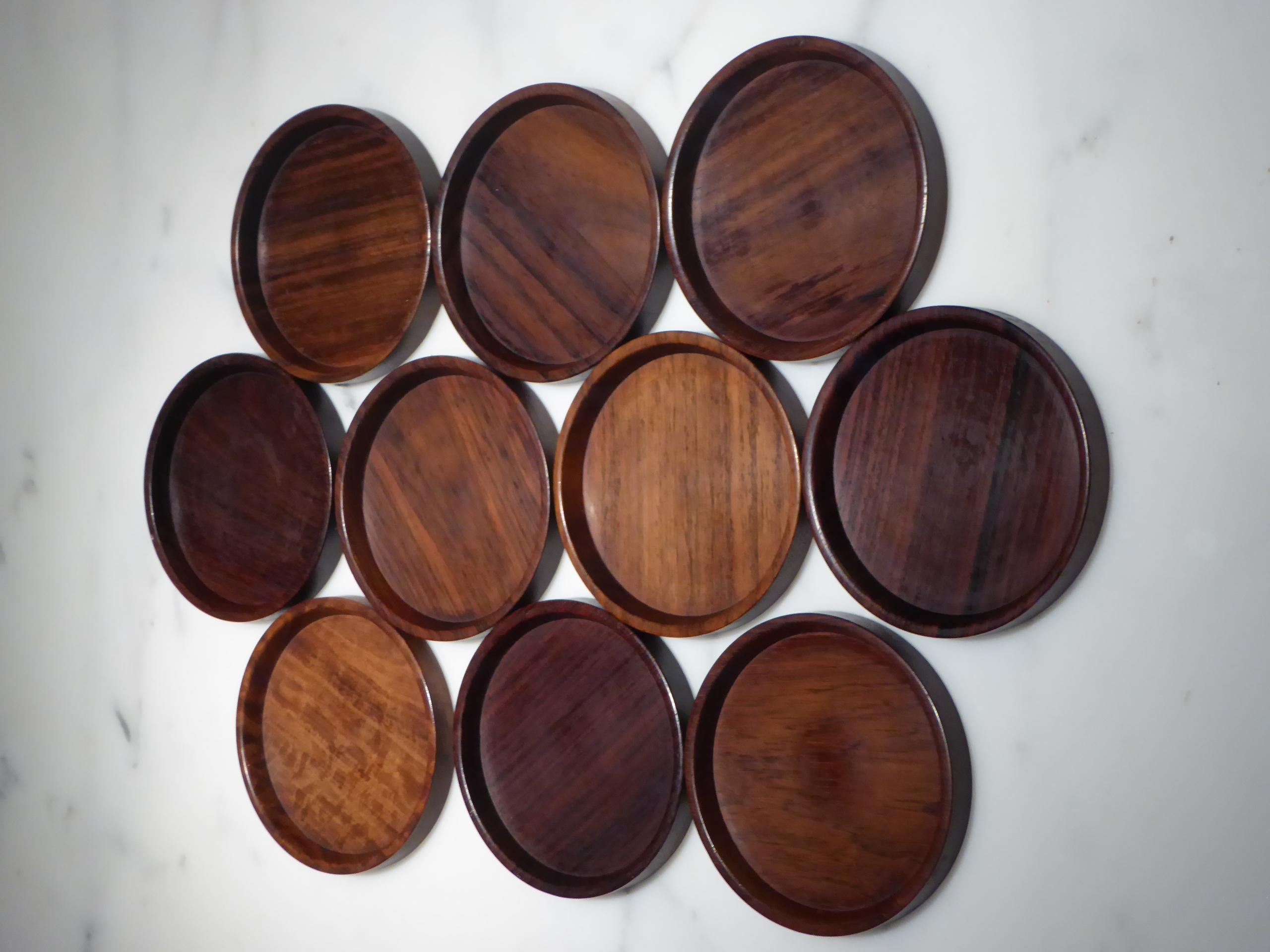 Mid-Century Modern Danish set of 10 carved rosewood coasters from Denmark, 1960s. All in used excellent condition. Each a beautiful creation carved out of solid piece of wood showing off the grain of the rosewood. Saap of Denmark,