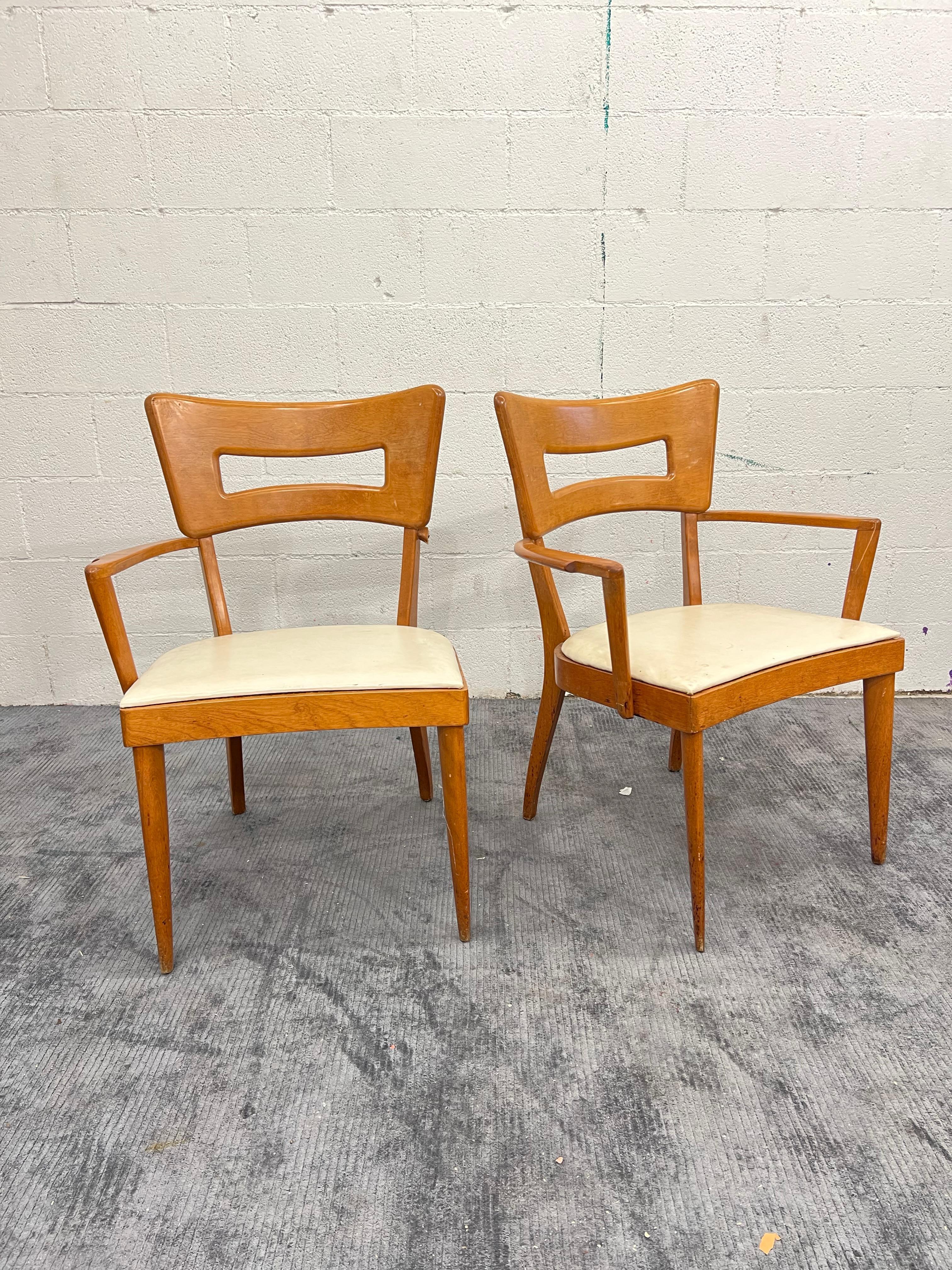 Condition note: please be aware one of the arm chairs is missing an armrest, will need to be rebuilt. 

Vintage Heywood Wakefield Dog bone Dining Chairs in Westwood finish. With original ivory faux leather. 

Side chair measurements: 33″ height 18″