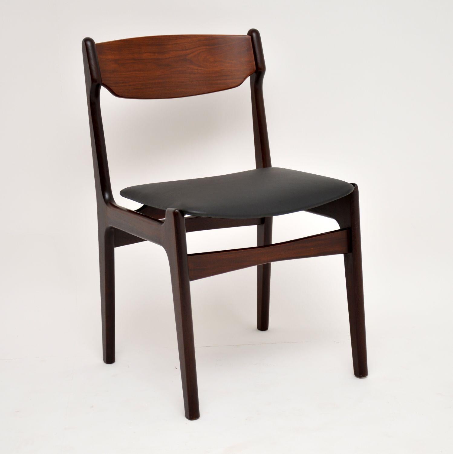 A stylish and extremely high quality set of six dining chairs, these were made in Denmark in the 1960s. The frames are solid wood and the seats have been newly upholstered in black vinyl. We have had the frames stripped and re-polished to a very