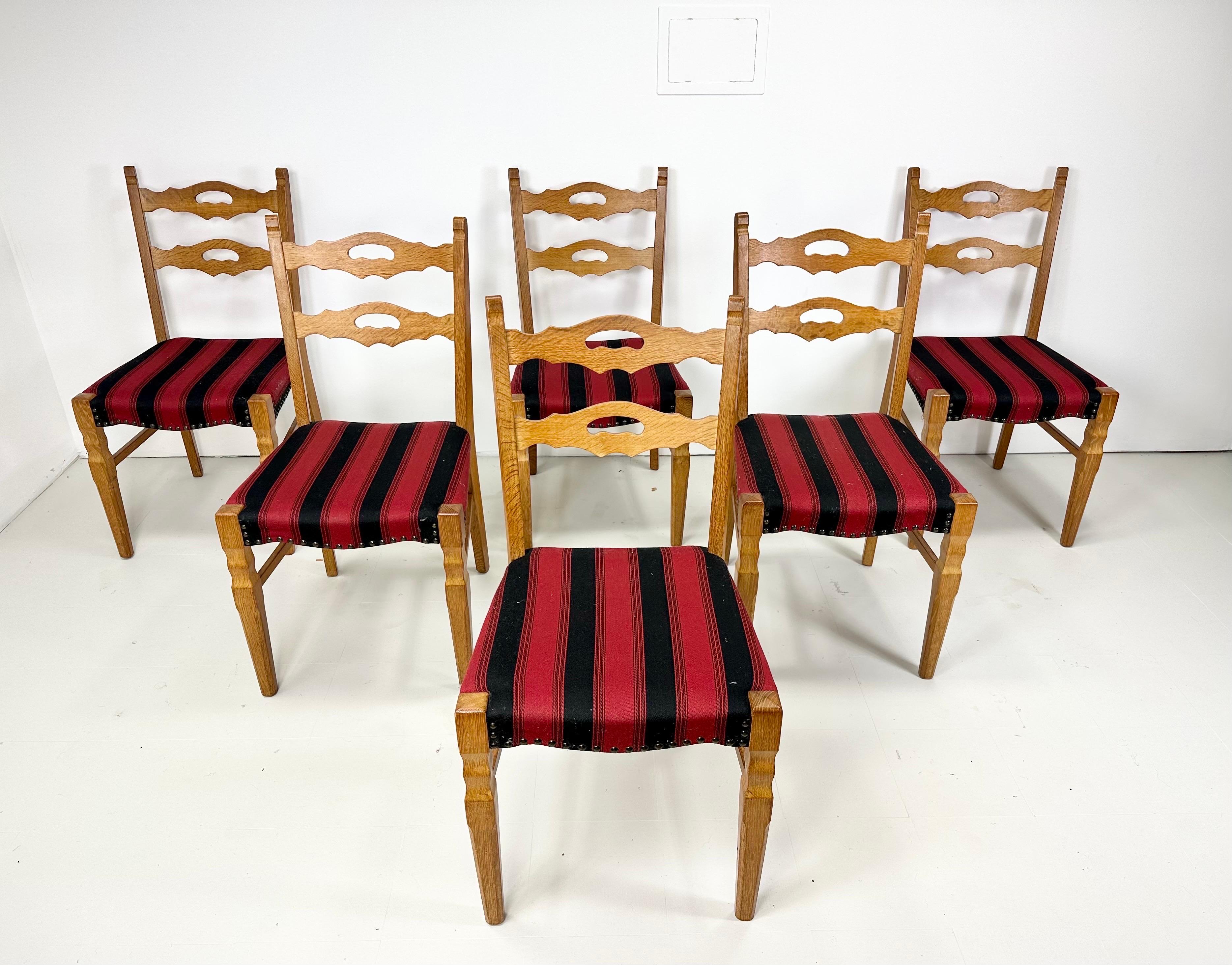 Set of 6 Dining Chairs designed by Henning Kjaernulf. Manufactured by EG Kvalitesmobel, Denmark, 1960’s. Chairs have a rustic warm finish and lines along with some classic mid century elements. Original upholstery and nailheads.
