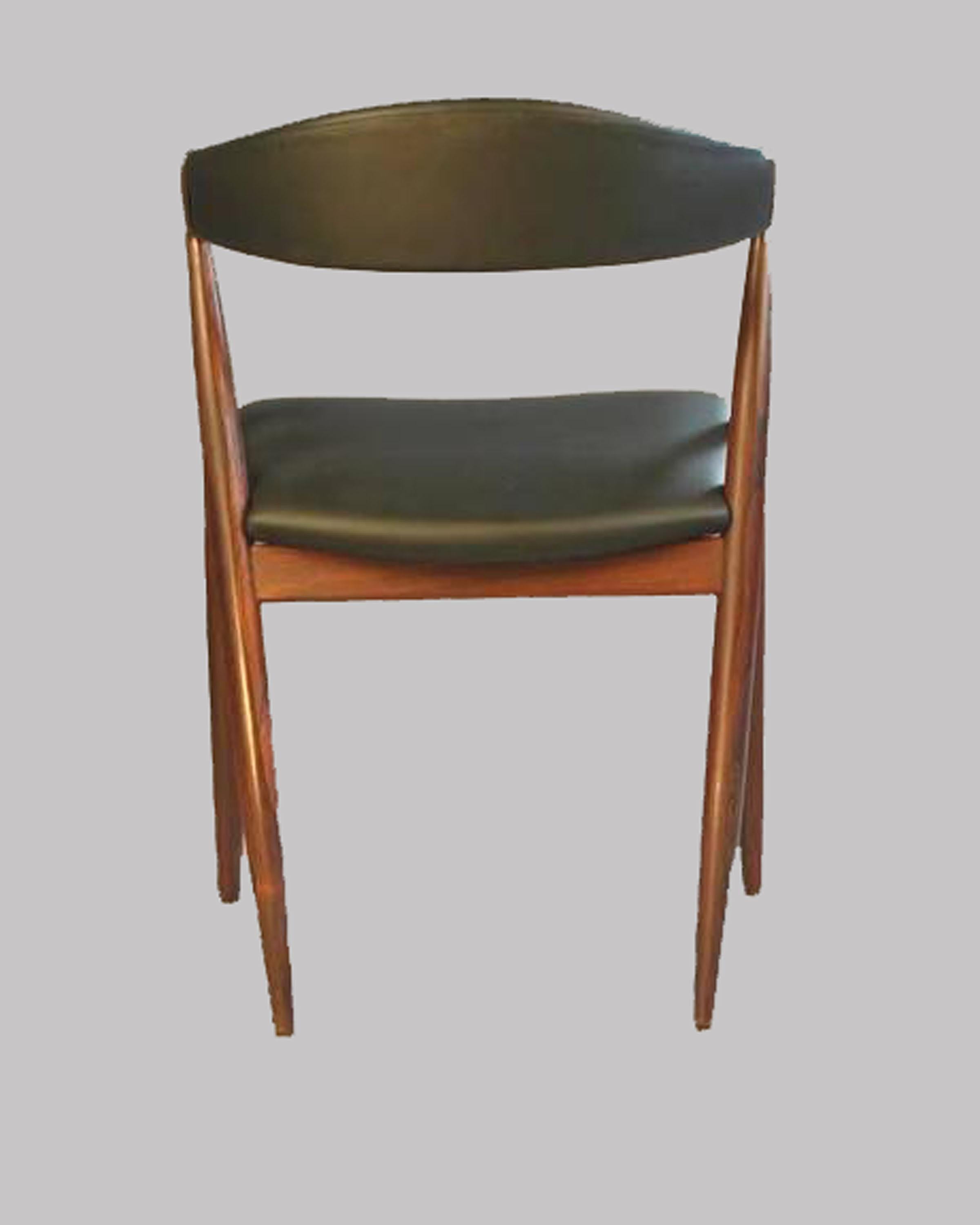 Set of eight A-frame dining chairs designed by Kai Kristiansen for Schou-Andersens Møbelfabrik. 

The chairs with their mixture of a straight lined A-frame combuned with an elegant curved backrest and seat feature Kai Kristiansens ability to