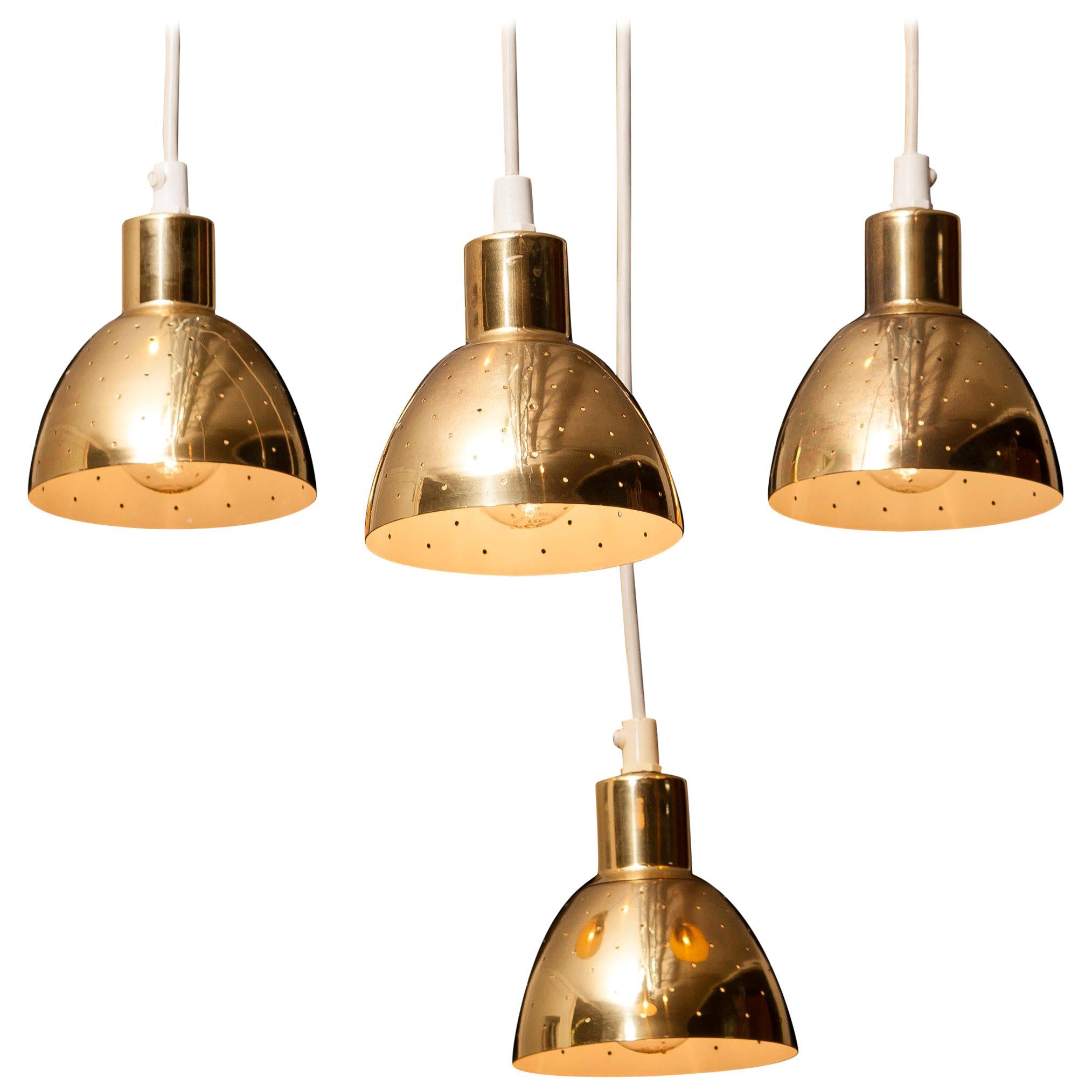 Great set of four brass pendants by Hans-Agne Jakobsson for Markaryd, Sweden.
Each lamp has perforation with gives the light a beautiful shining.
They are in a good and working condition.
Period 1960s.
Dimensions: H 11 cm, ø 11 cm.