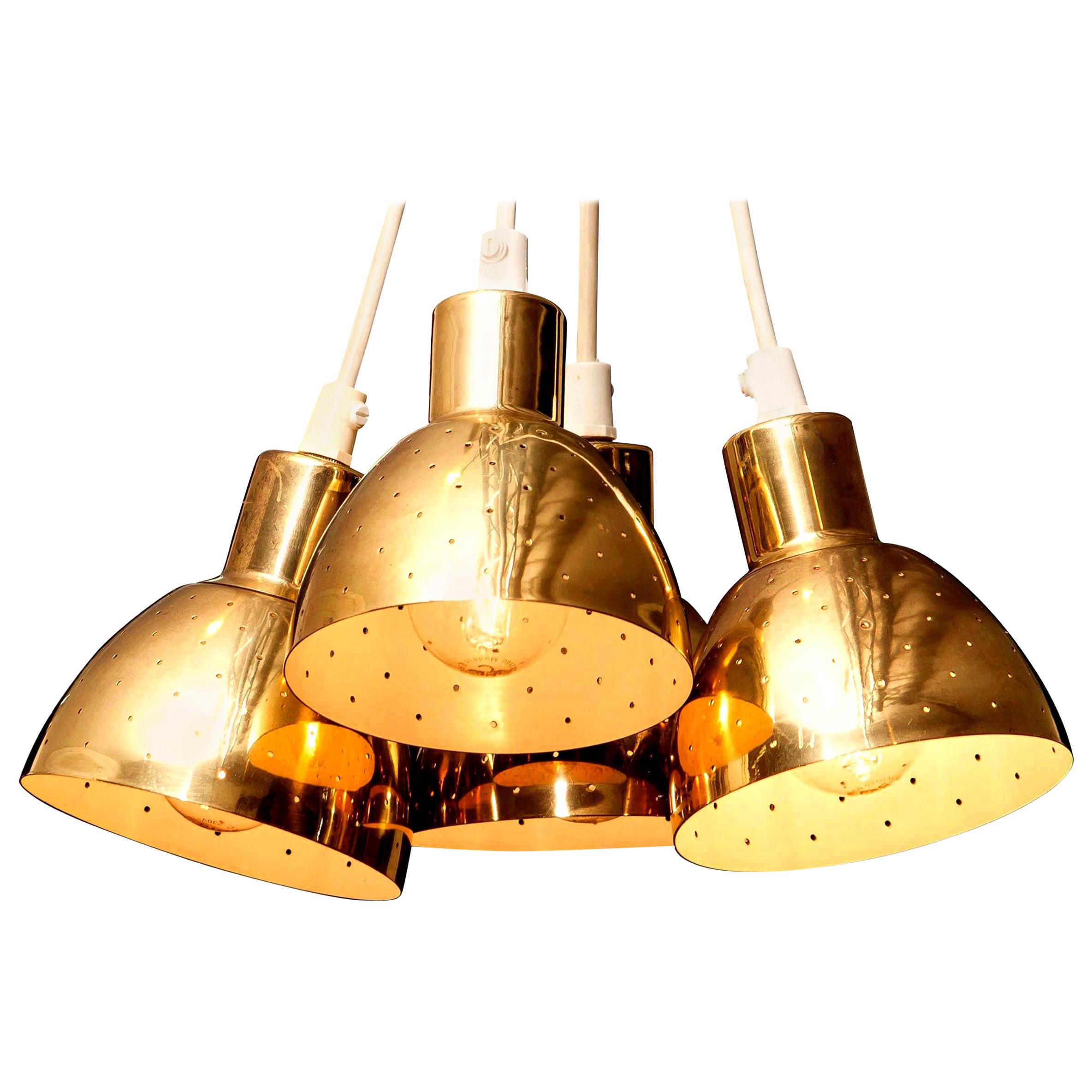 Great set of four brass pendants by Hans-Agne Jakobsson for Markaryd, Sweden.
Each lamp has perforation with gives the light a beautiful shining.
They are in a good and working condition.
Period: 1960s.
Dimensions: H 11 cm, Ø 11 cm.